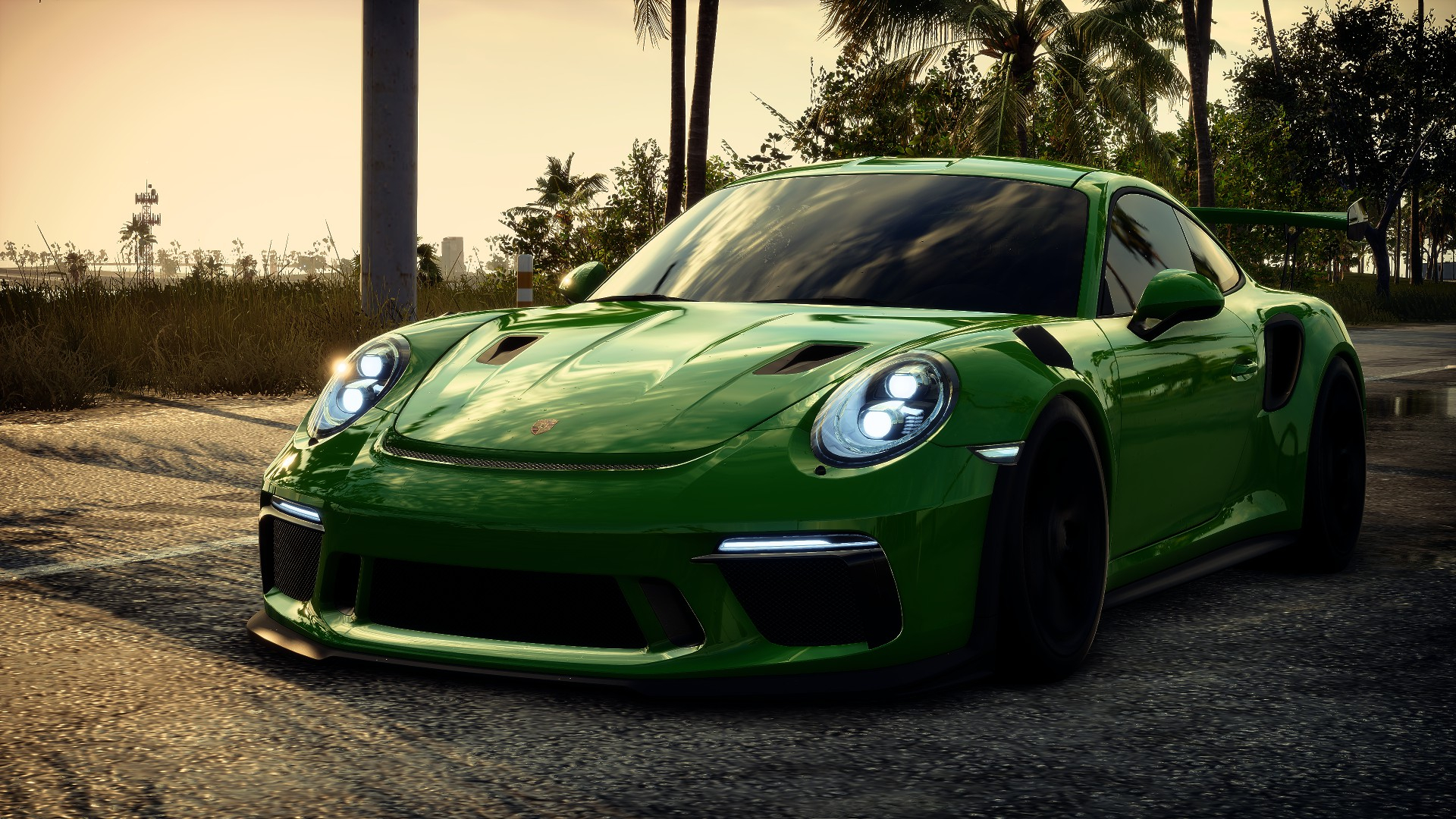 Free photo A green porsche 911 at sunset