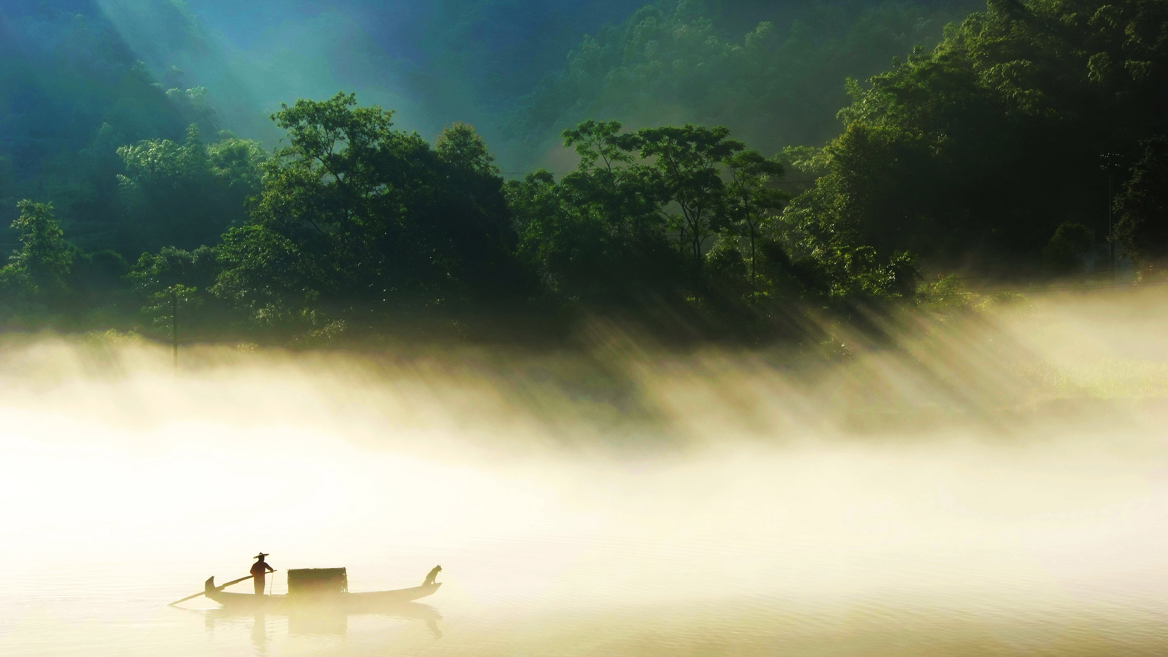 A merchant ship hides behind a curtain of sunlight
