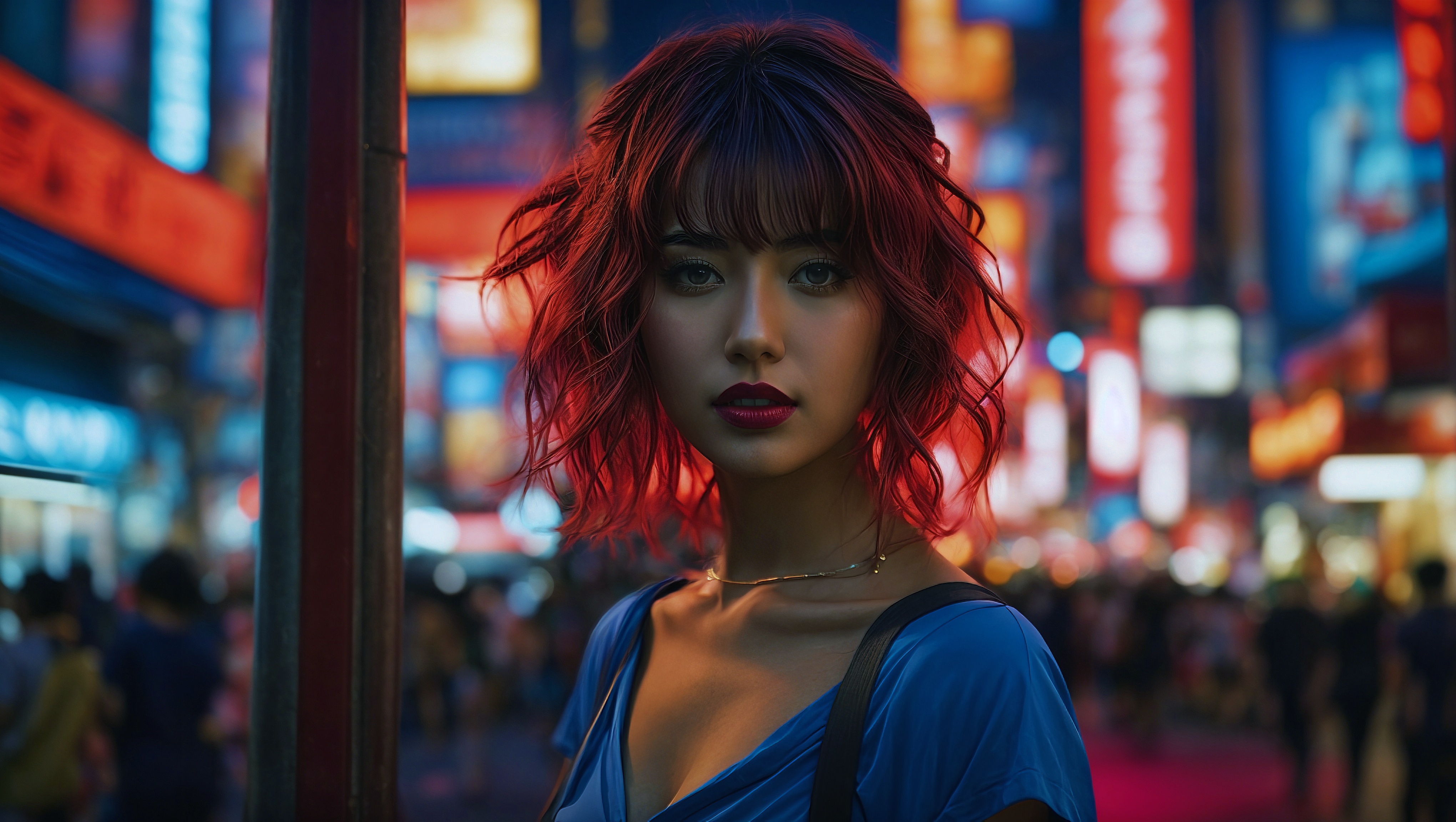 Free photo A woman with red hair standing in the middle of a street at night