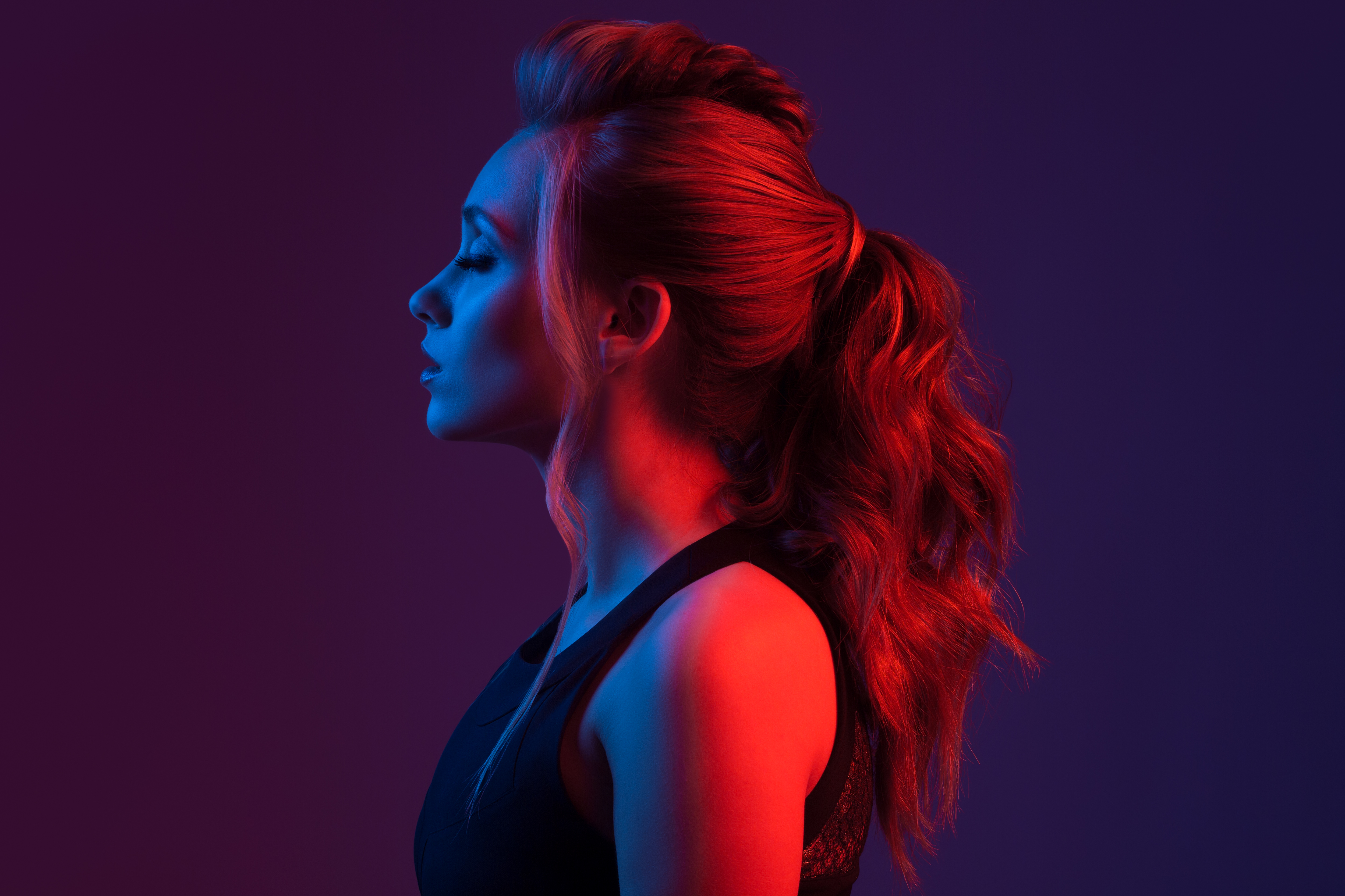 Portrait of a girl with gorgeous hair in multicolored light
