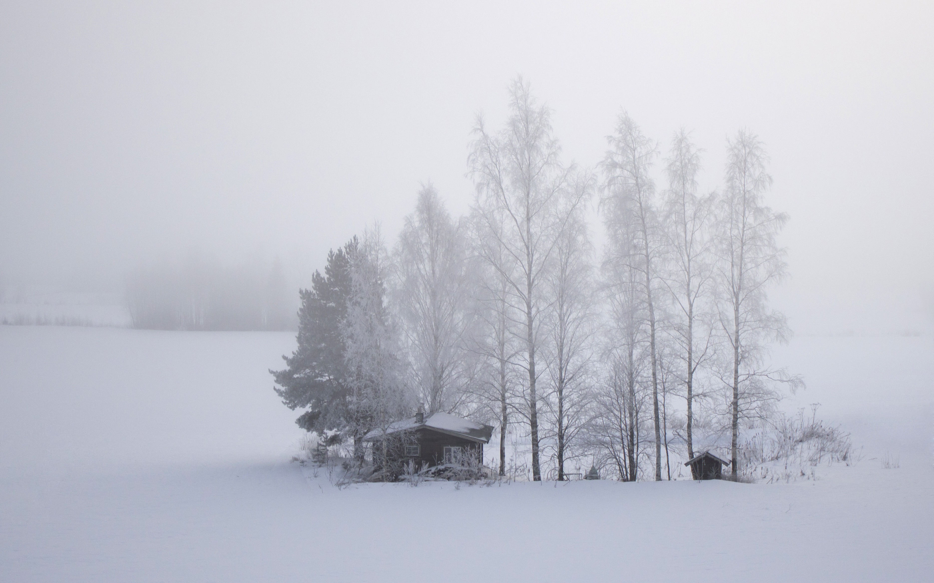 Free photo A snowy field with a lonely house