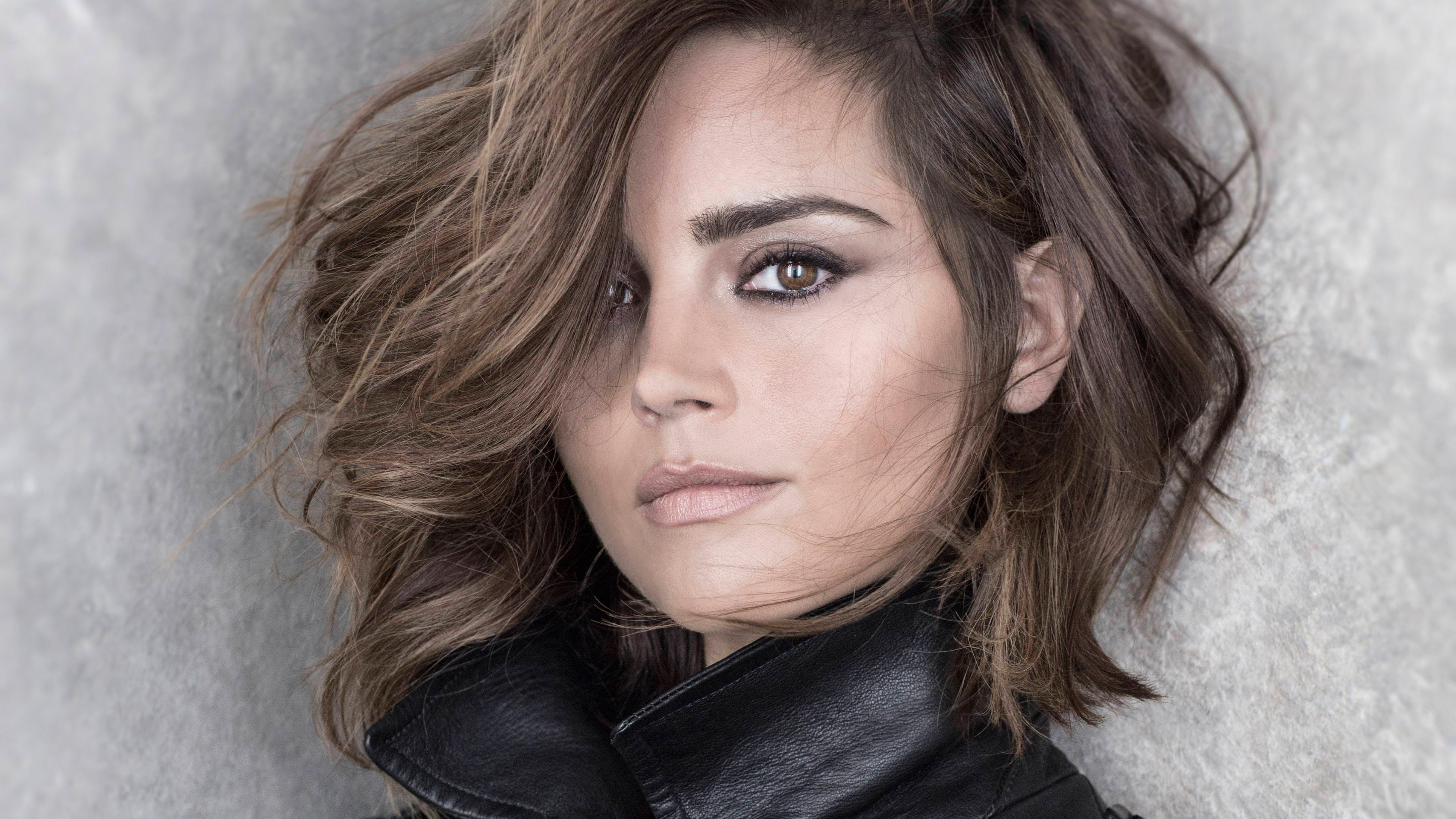 Portrait of actress Jenna Coleman on a light background