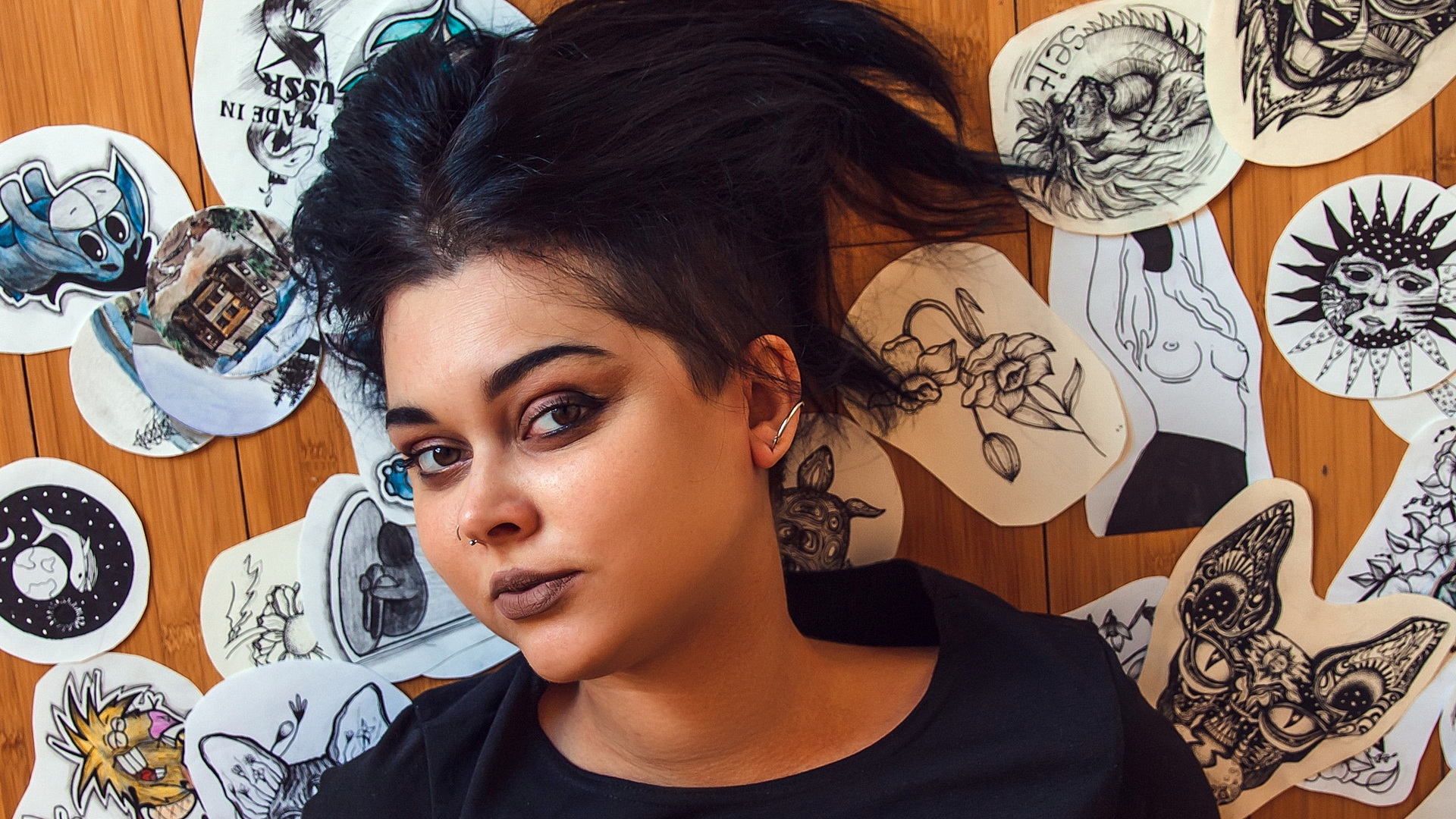 A portrait of model Adele Adamov lying on the floor of a room