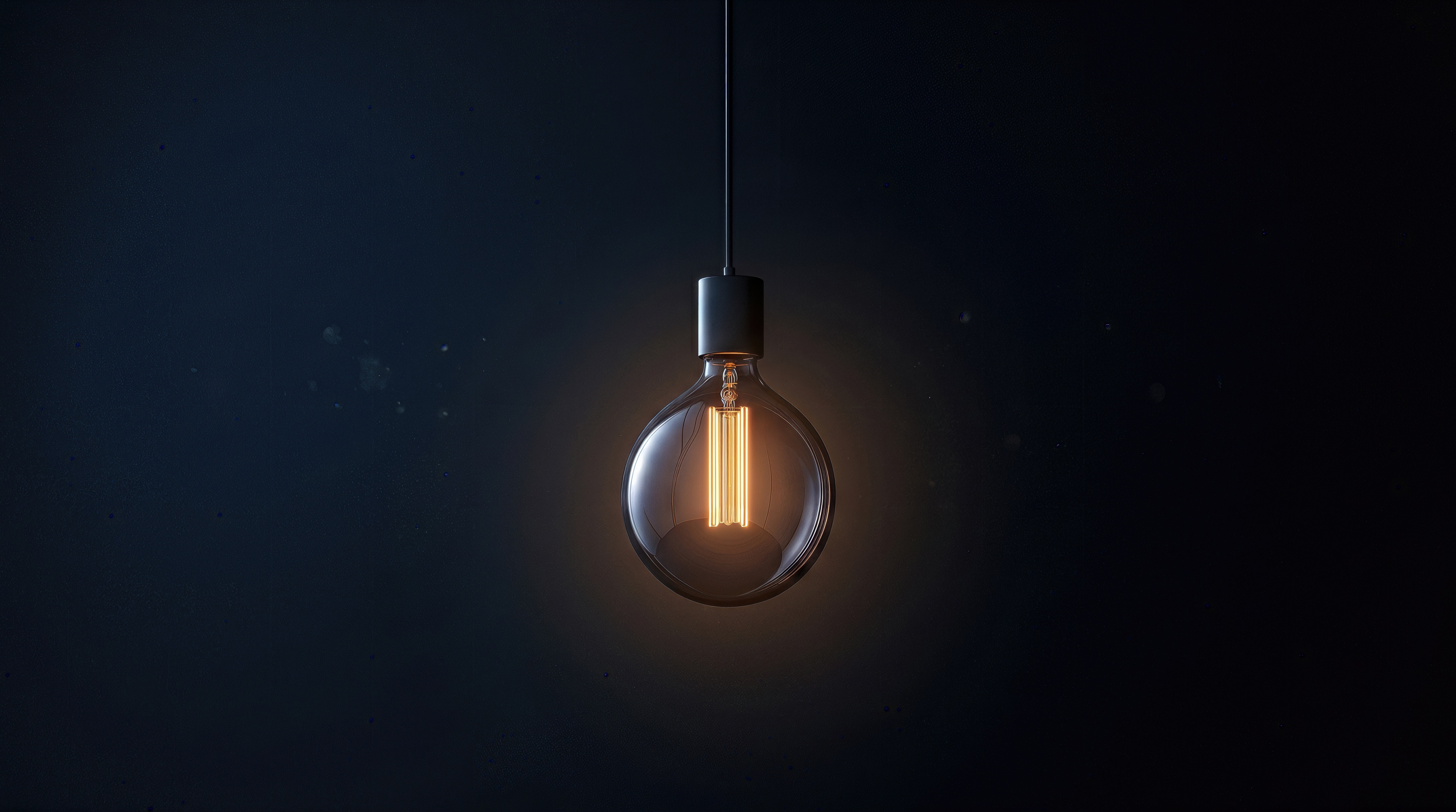 Free photo Minimalistic art with a warm glowing light bulb on a black background.