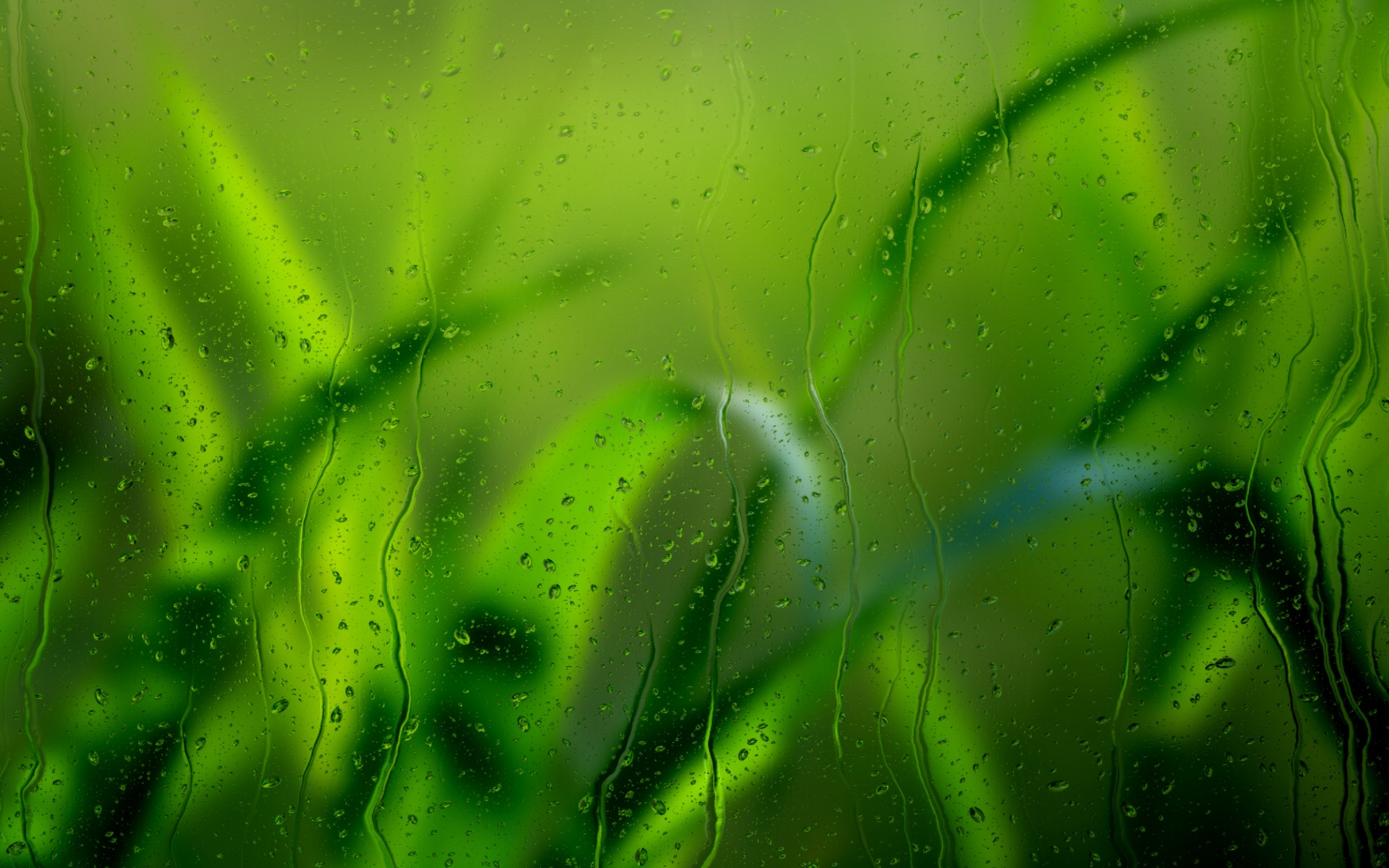 The texture of rain falling on a window pane on a green background