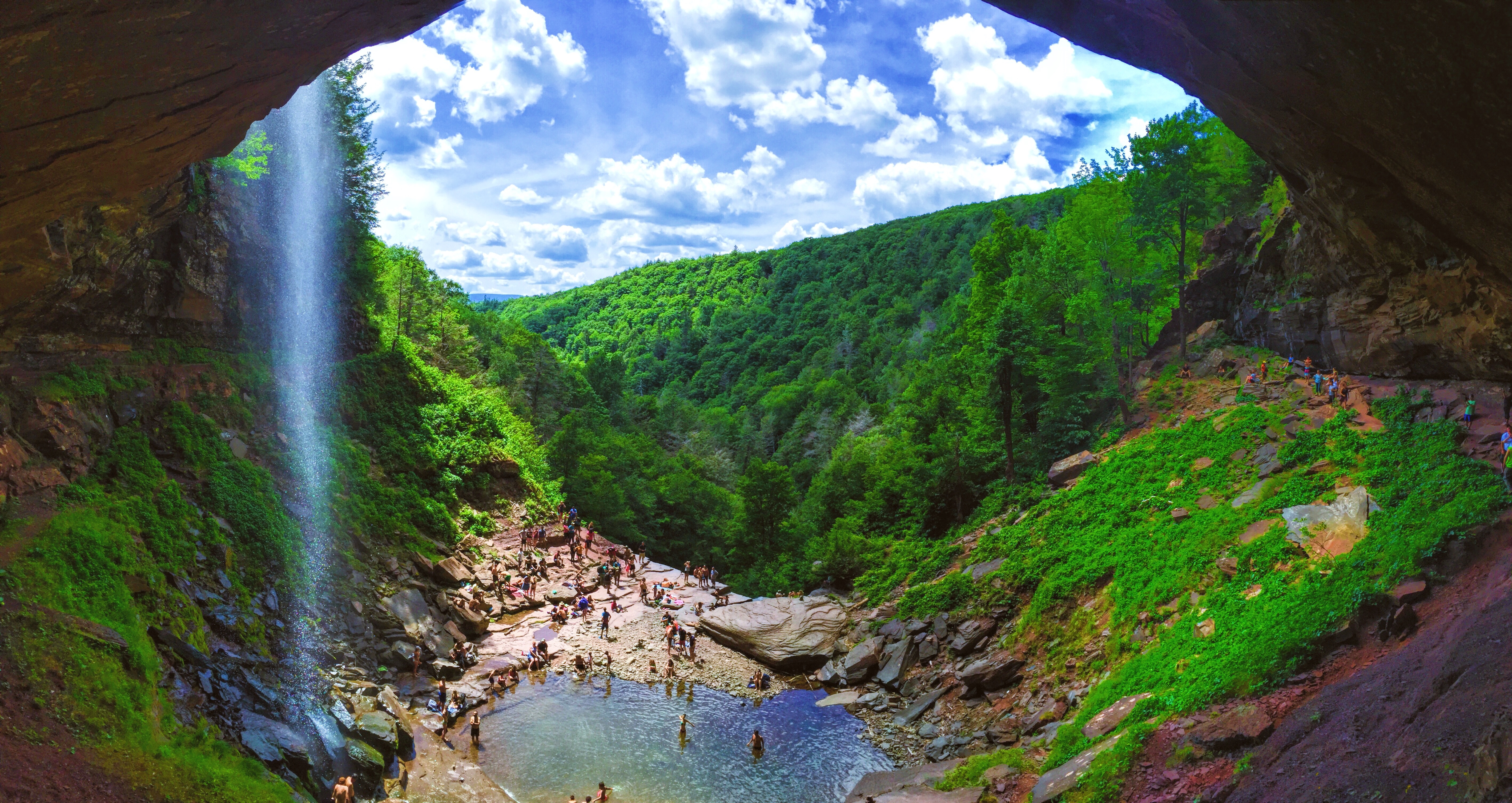 Free photo Waterfall in the mountains near a cave