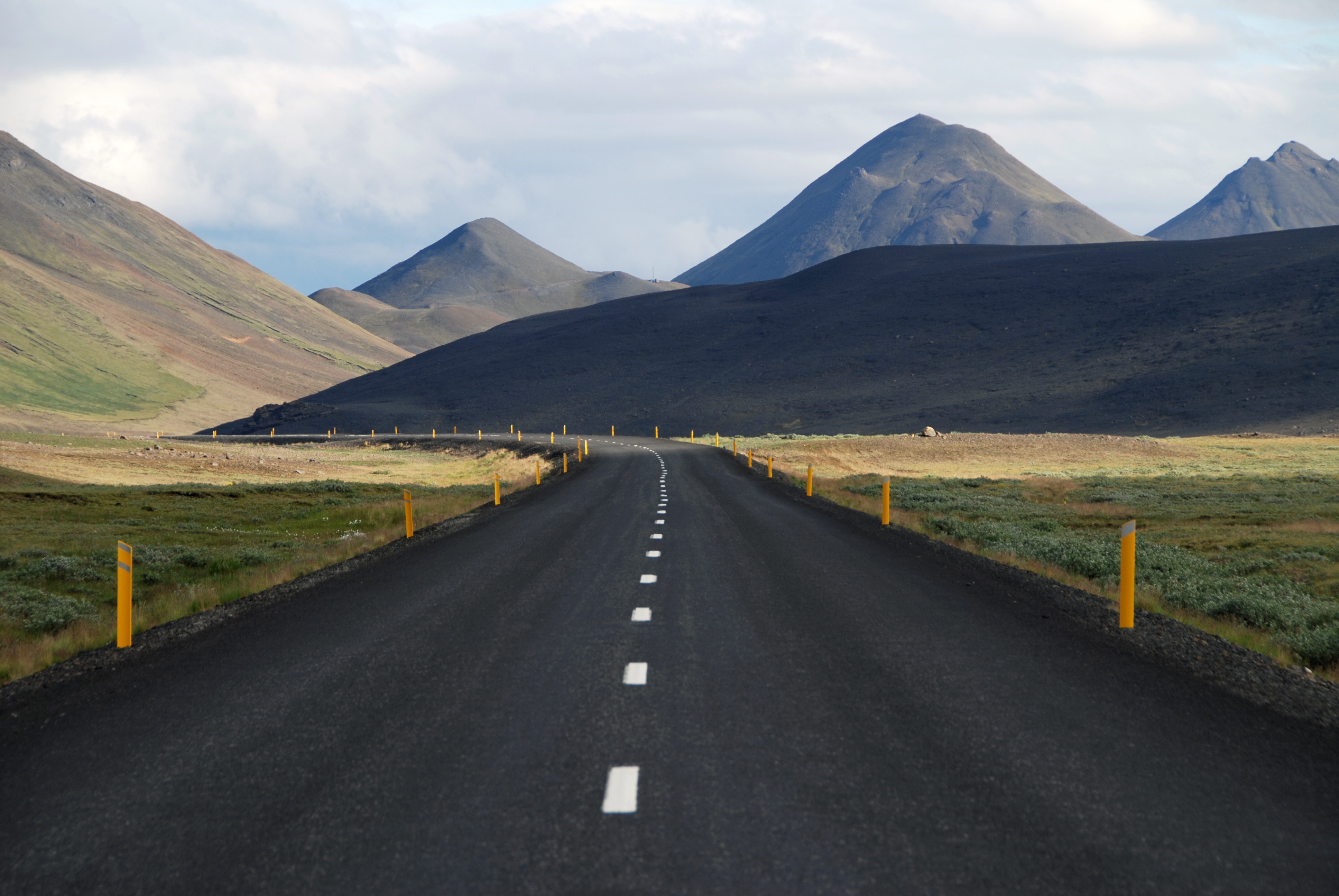 Free photo The long paved road runs between the hills