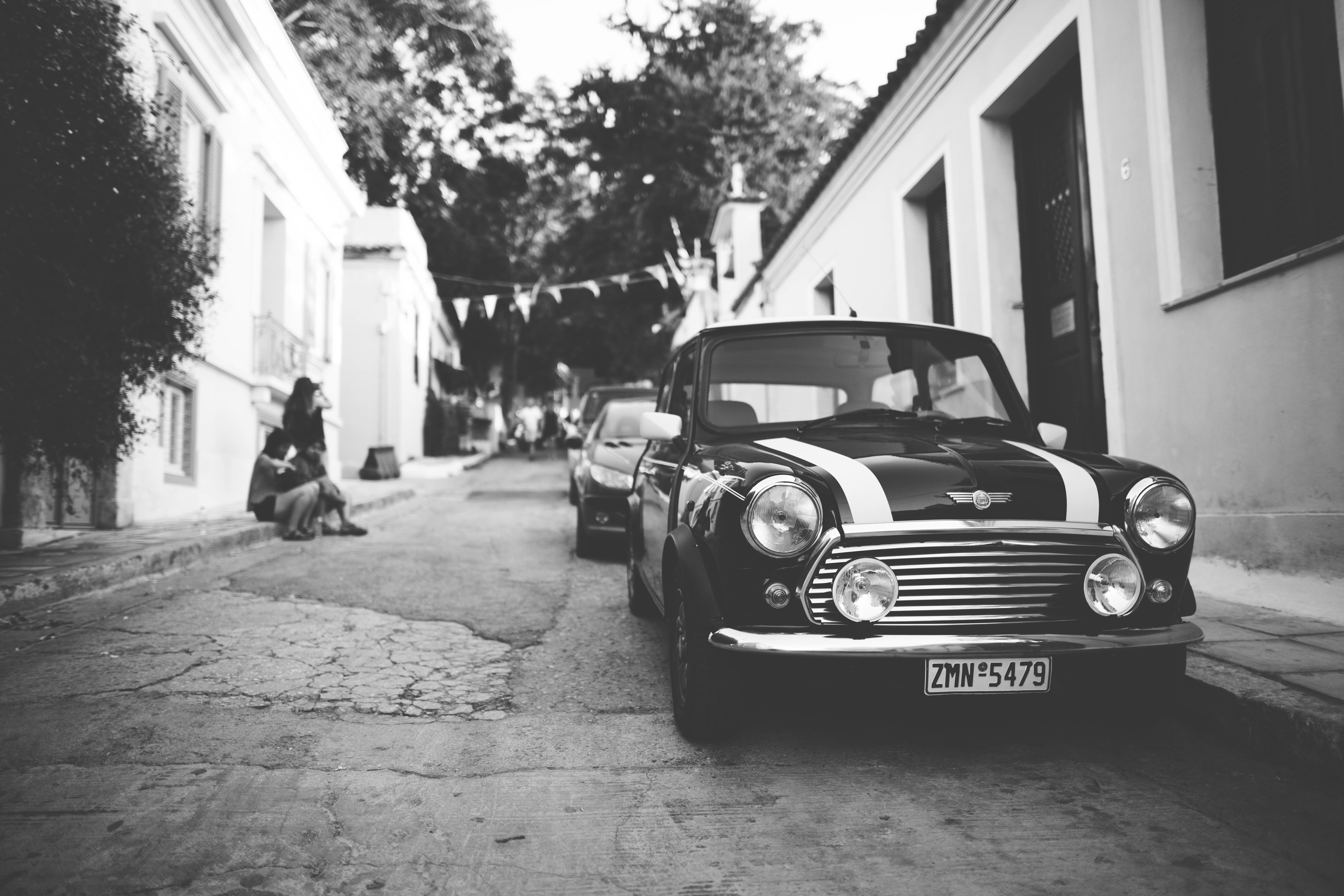 Free photo Black and white photo of Mini Cooper with white stripes