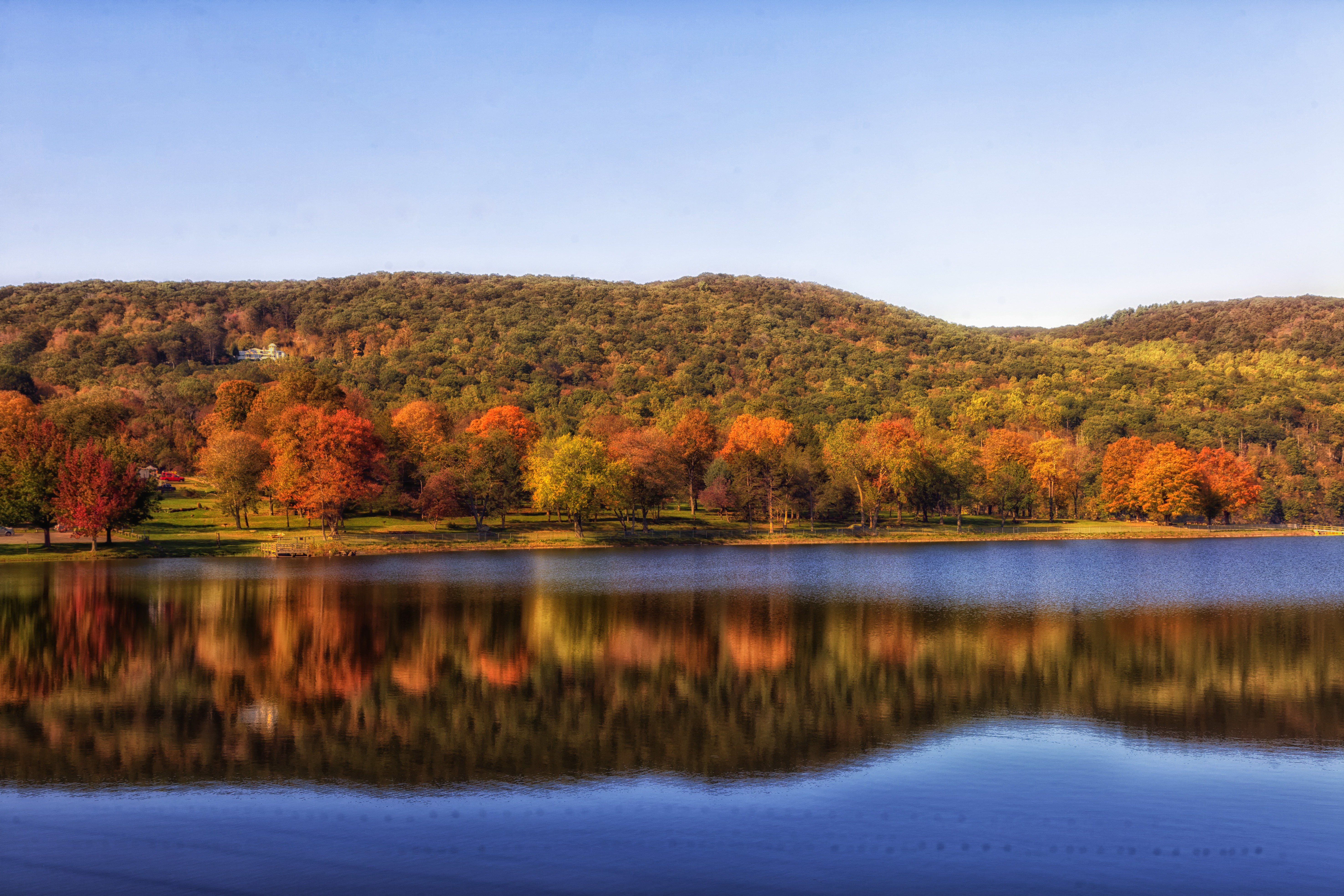 Autumn landscape on the lake shore with a beautiful forest