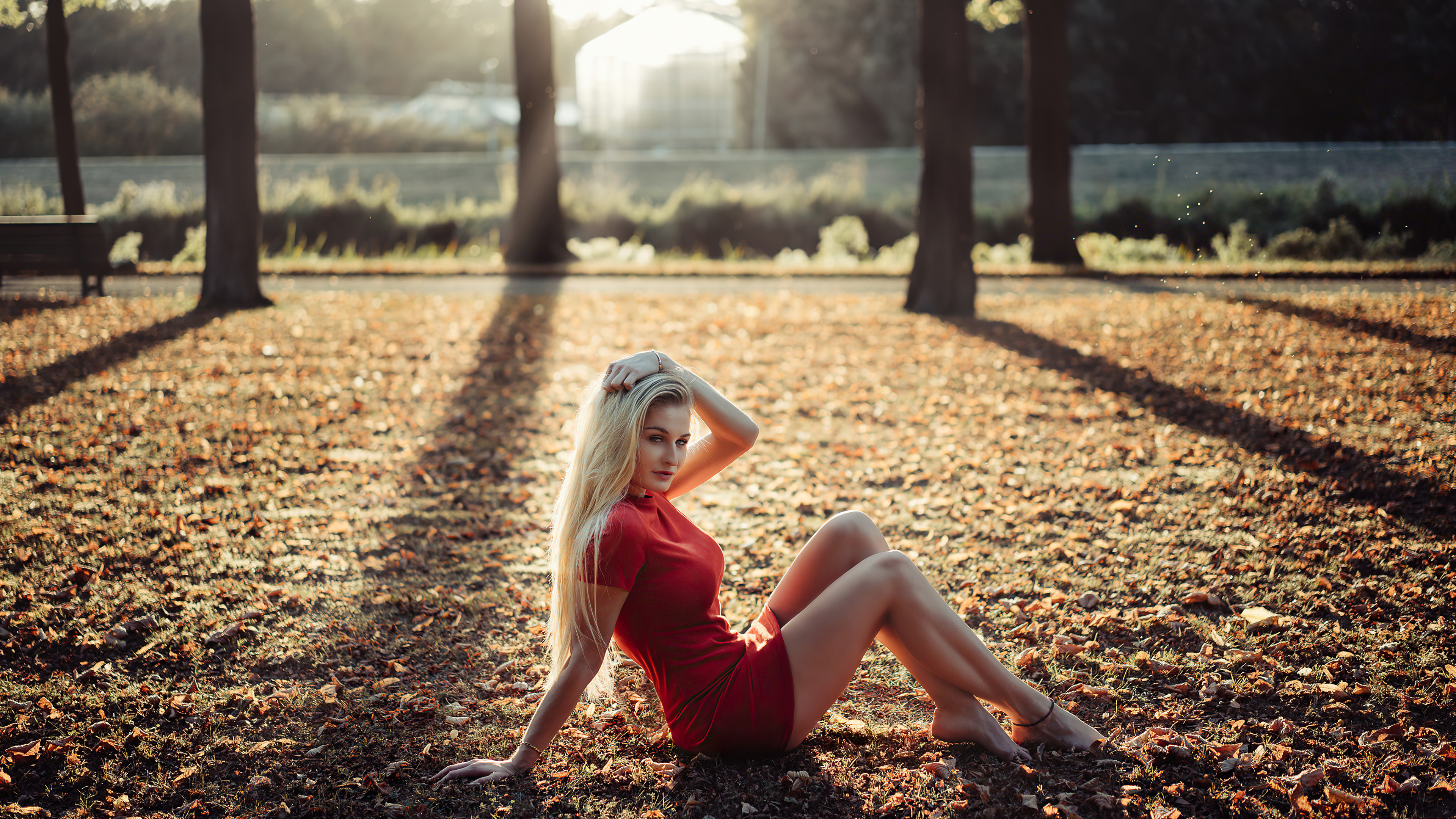 A girl in a red dress in the morning at sunrise