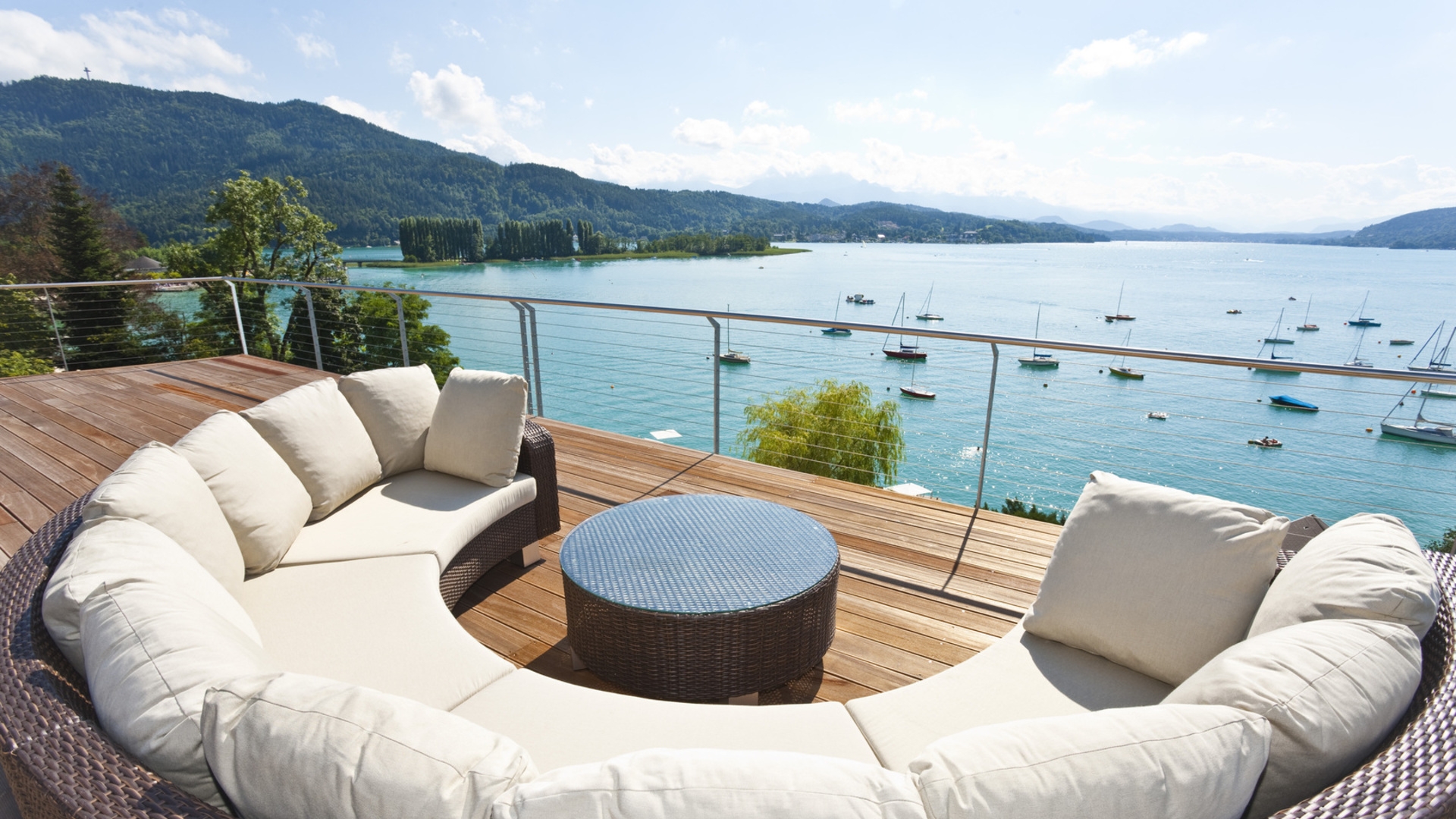 Balcony with sofas and views of the lake and mountains.