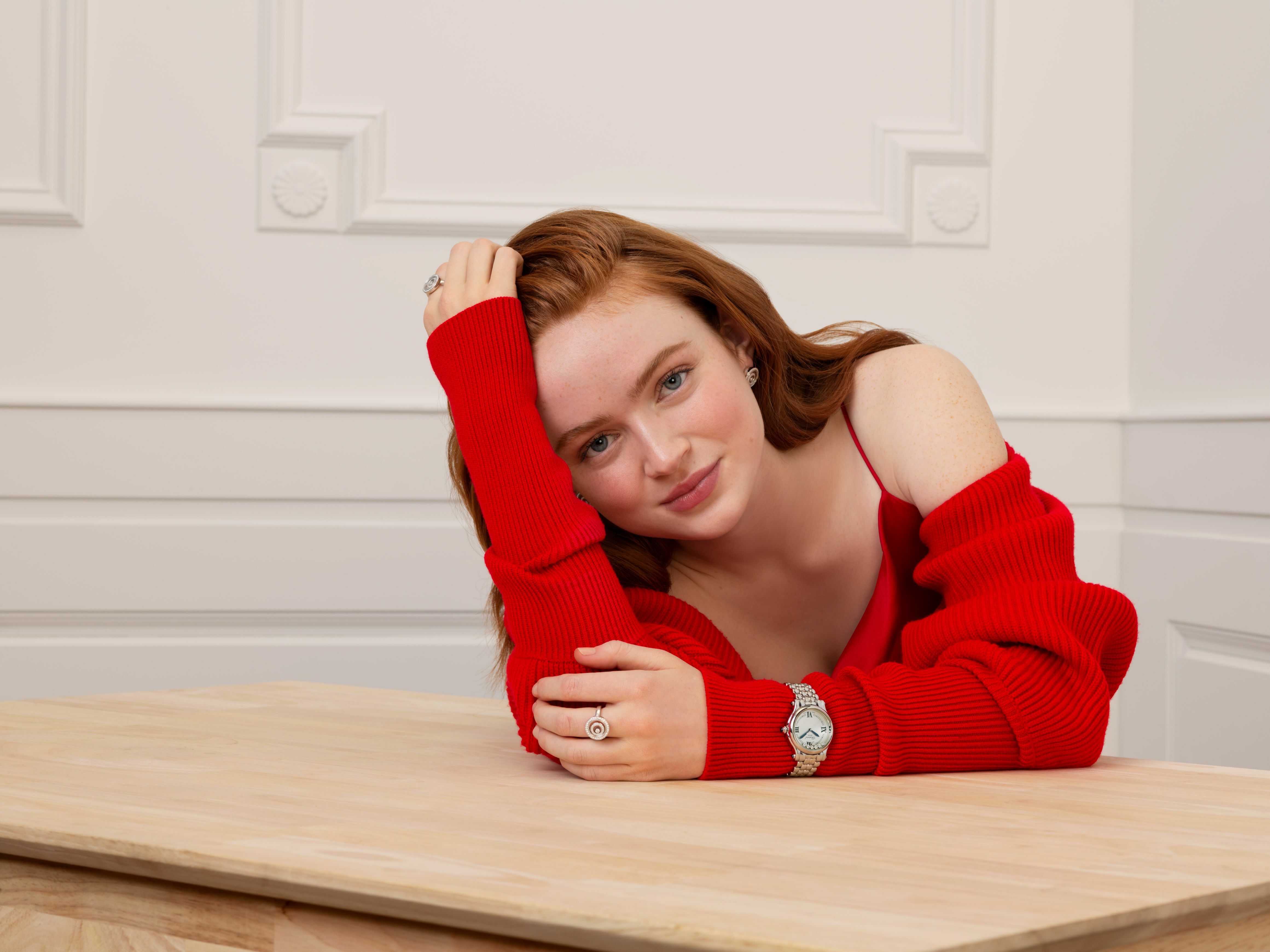 Redheaded Sadie Sink in a red sweater