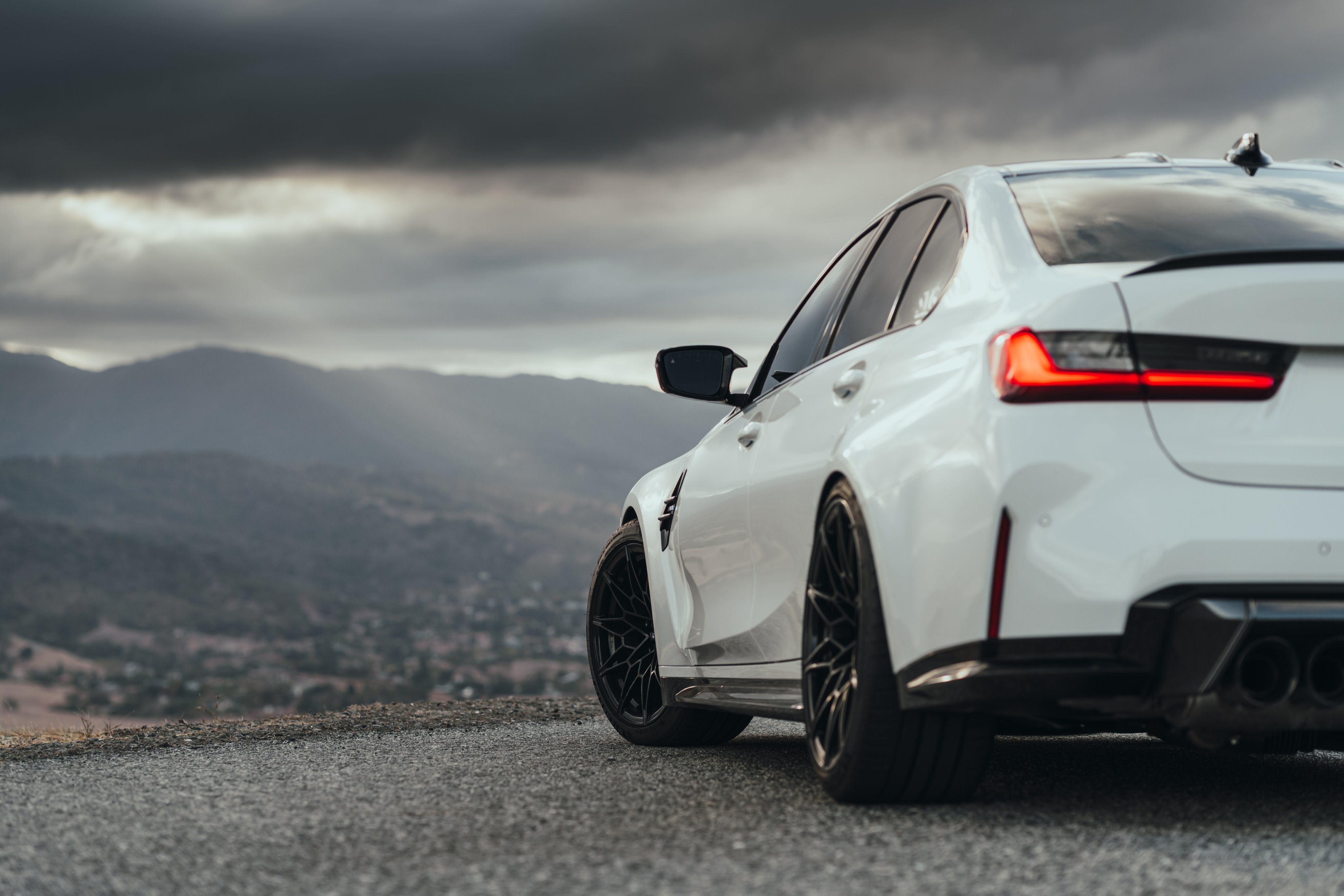 Free photo White BMW M3 g80 in the background of the mountains