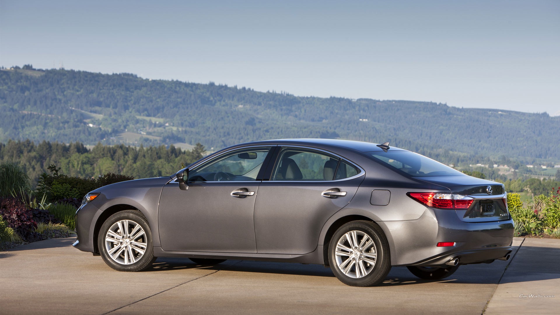 Silver Lexus ES 350 sedan on the background of hills