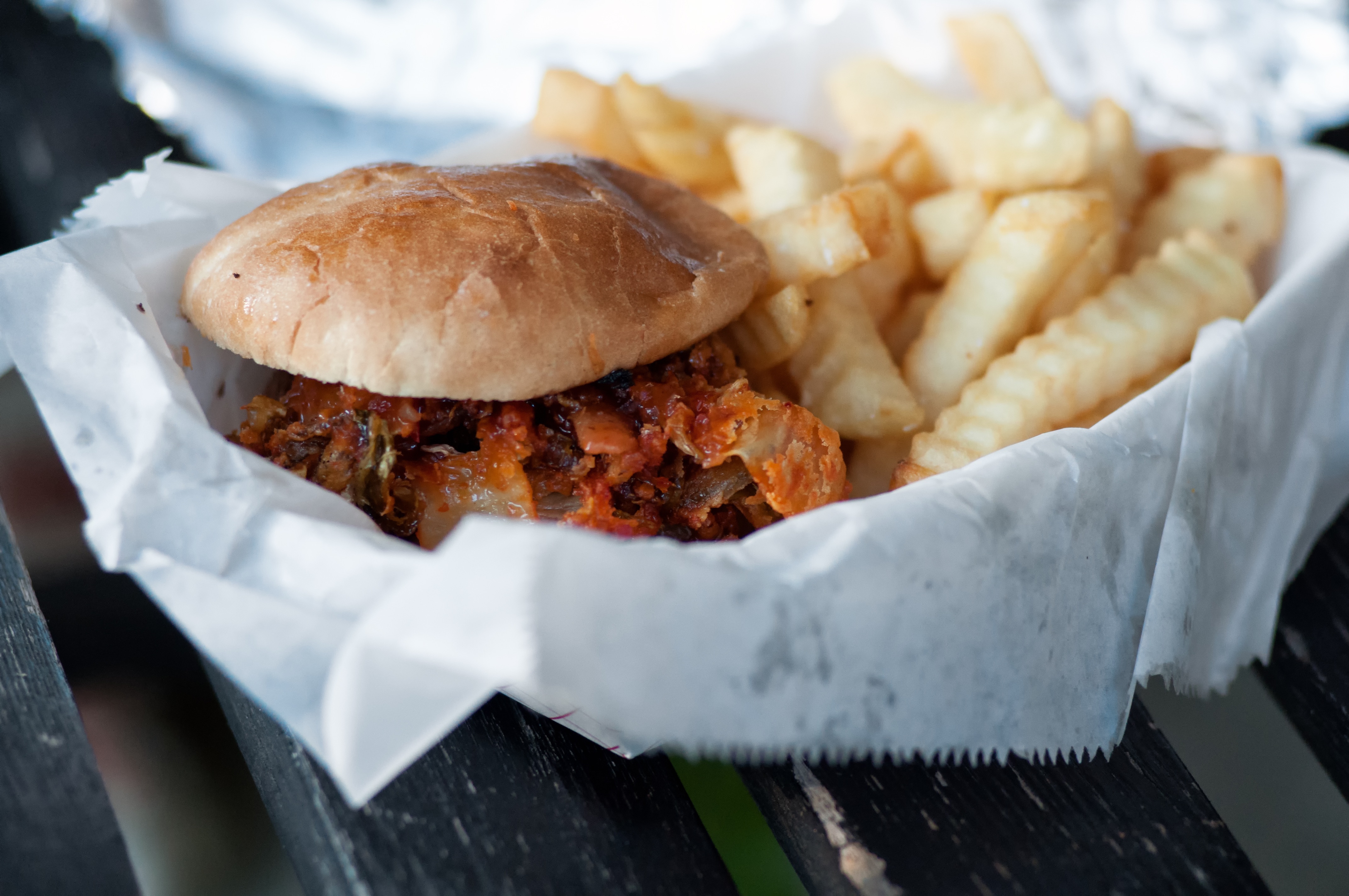 Free photo Hamburger and fries wrapped in paper.