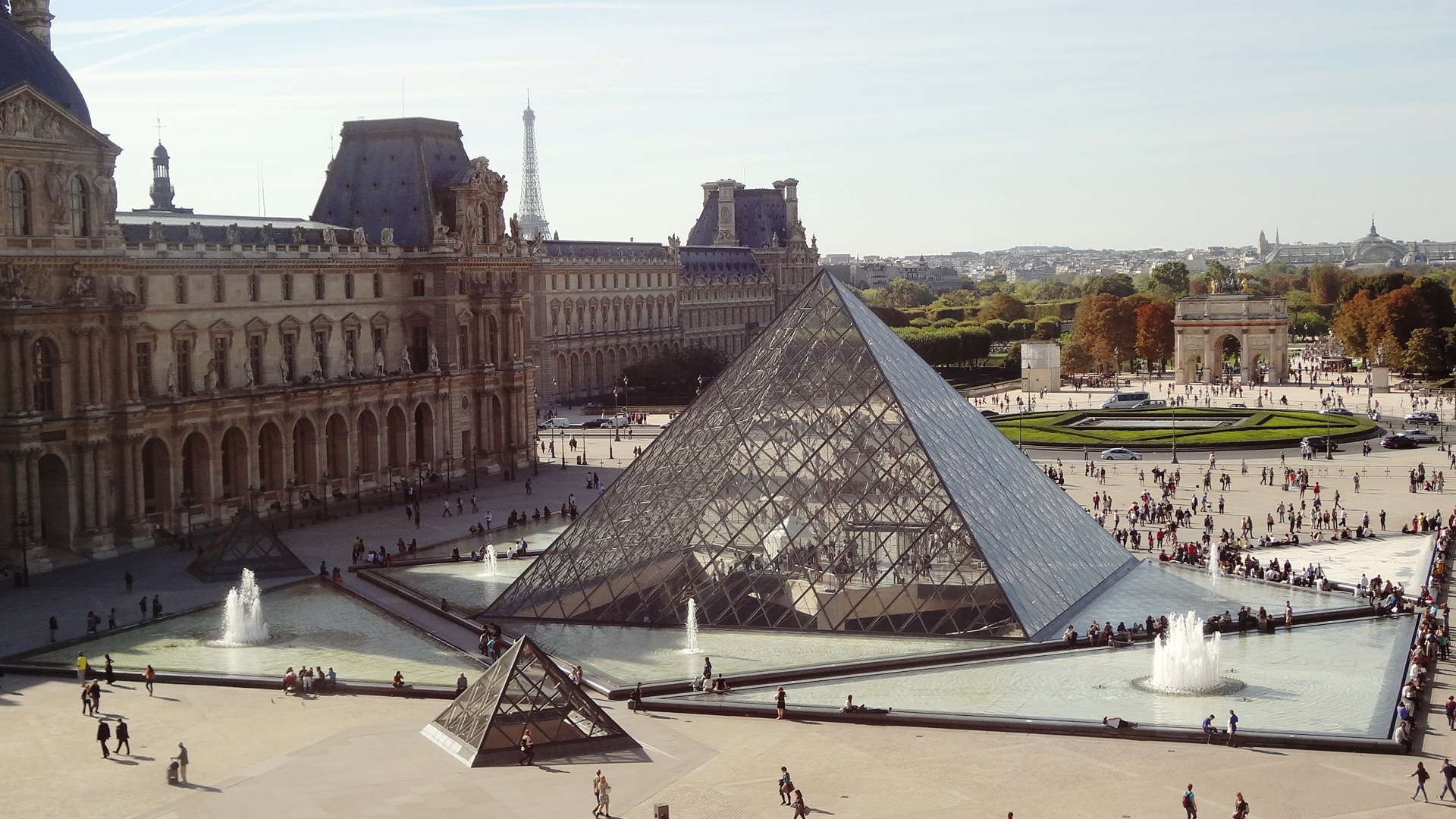 Free photo A transparent pyramid on the roof of a house