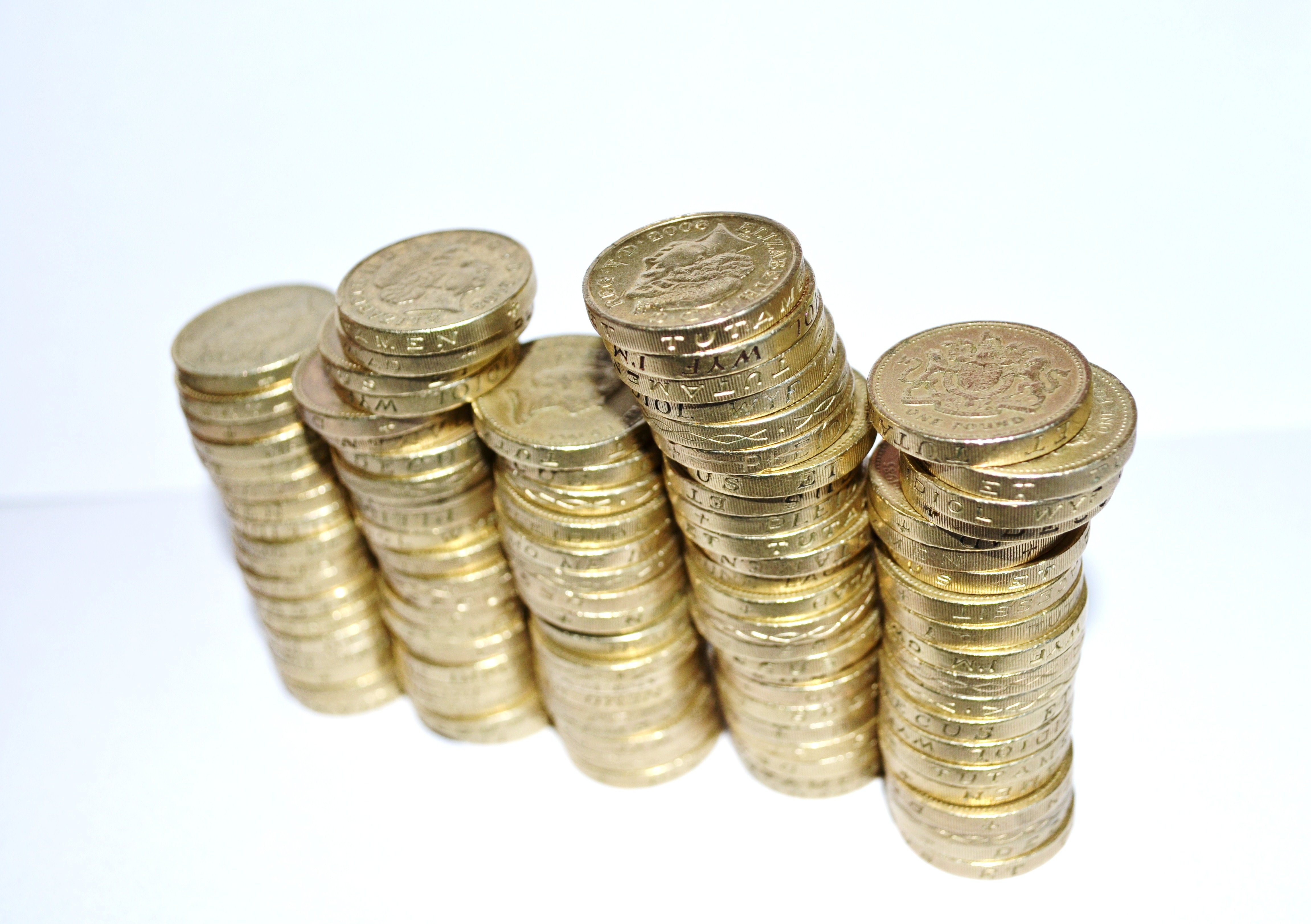 Free photo Stacks of coins on a light background