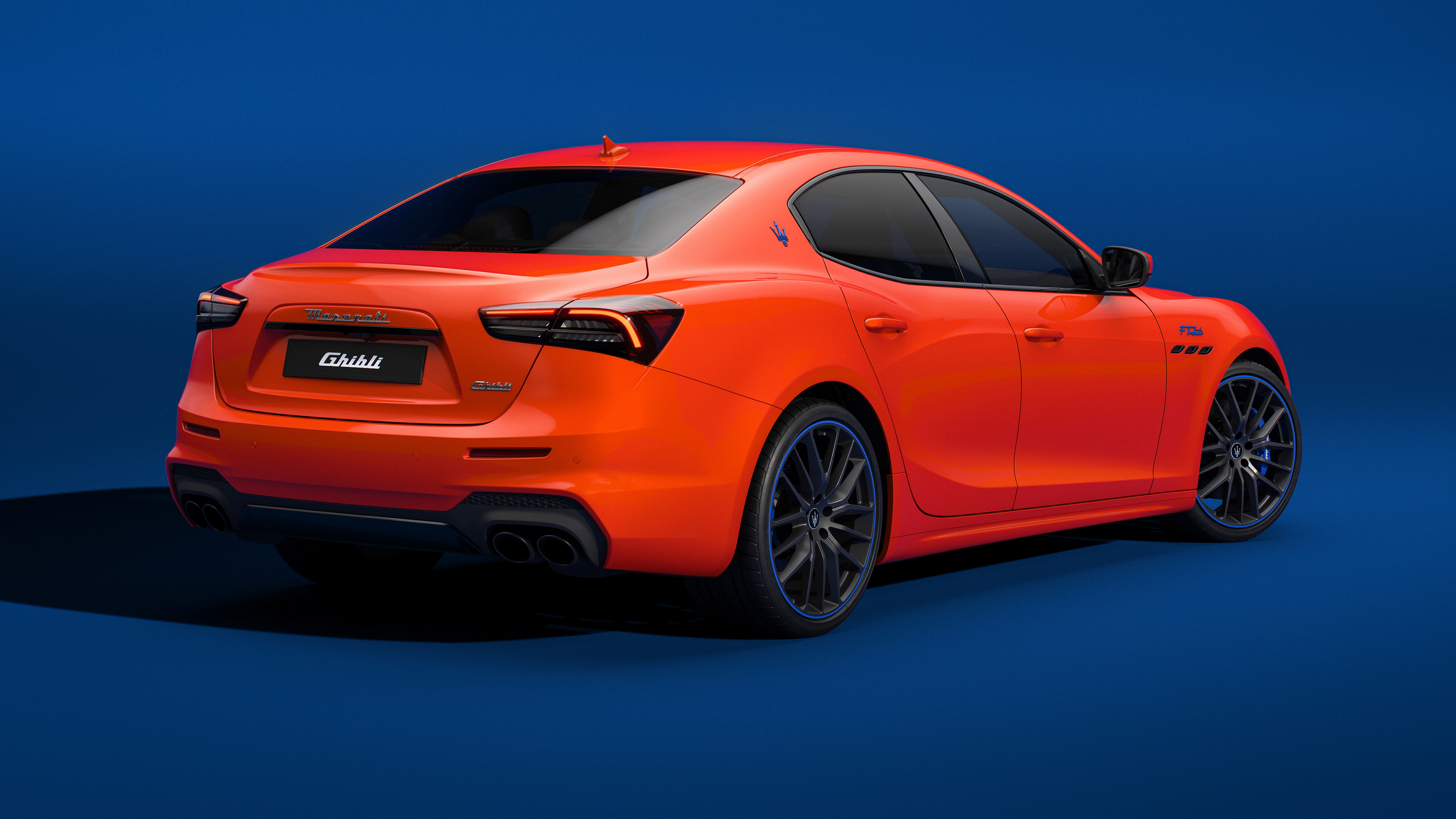 Free photo Maserati Ghibli orange on blue background