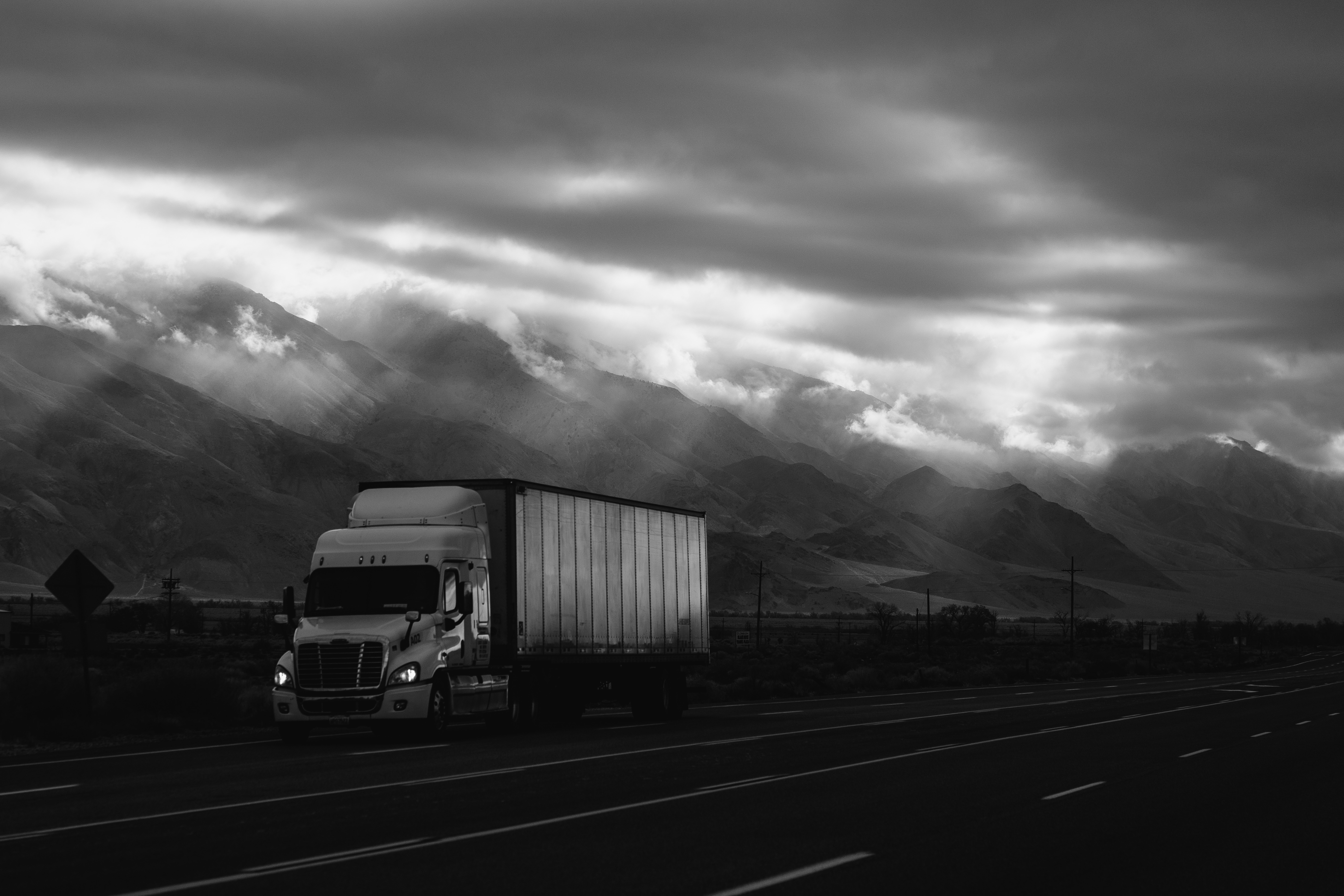 一辆货车在阴天的高速公路上行驶。