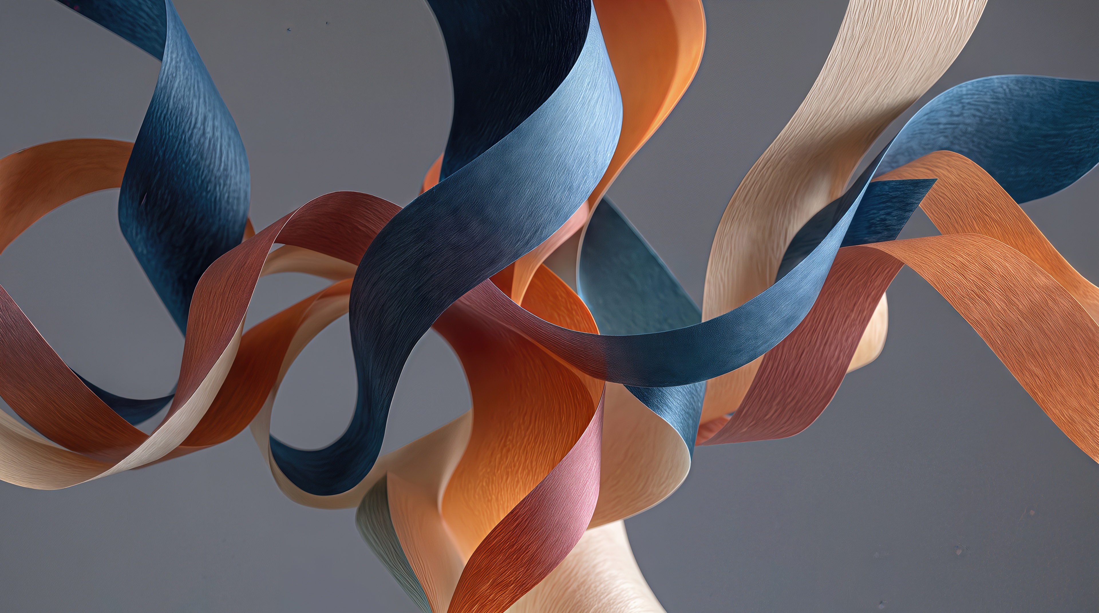 Free photo Elegant multicolored ribbons with a paper texture are smoothly intertwined in the air on a laconic gray background.