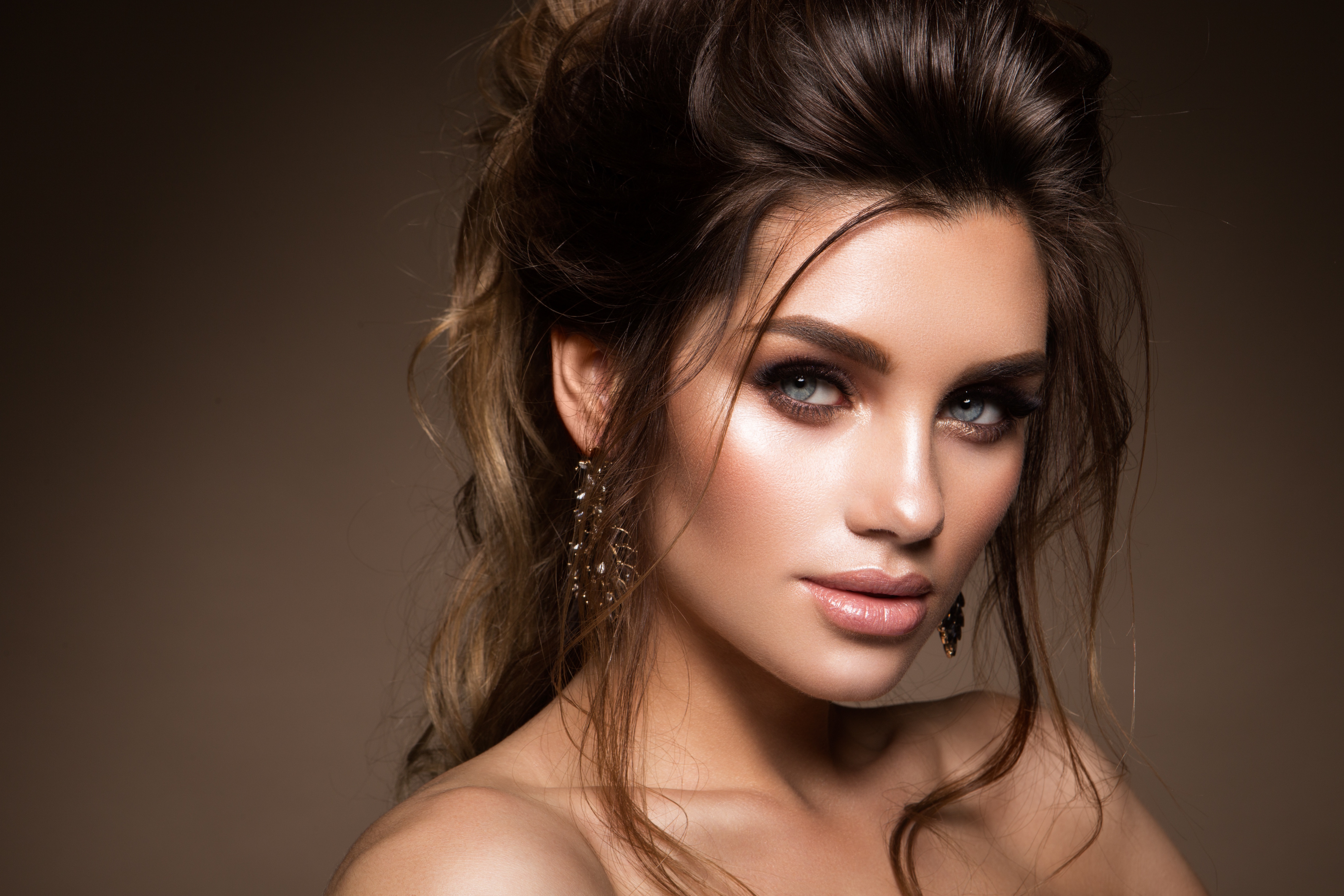 A beautiful brown-haired woman in chic makeup