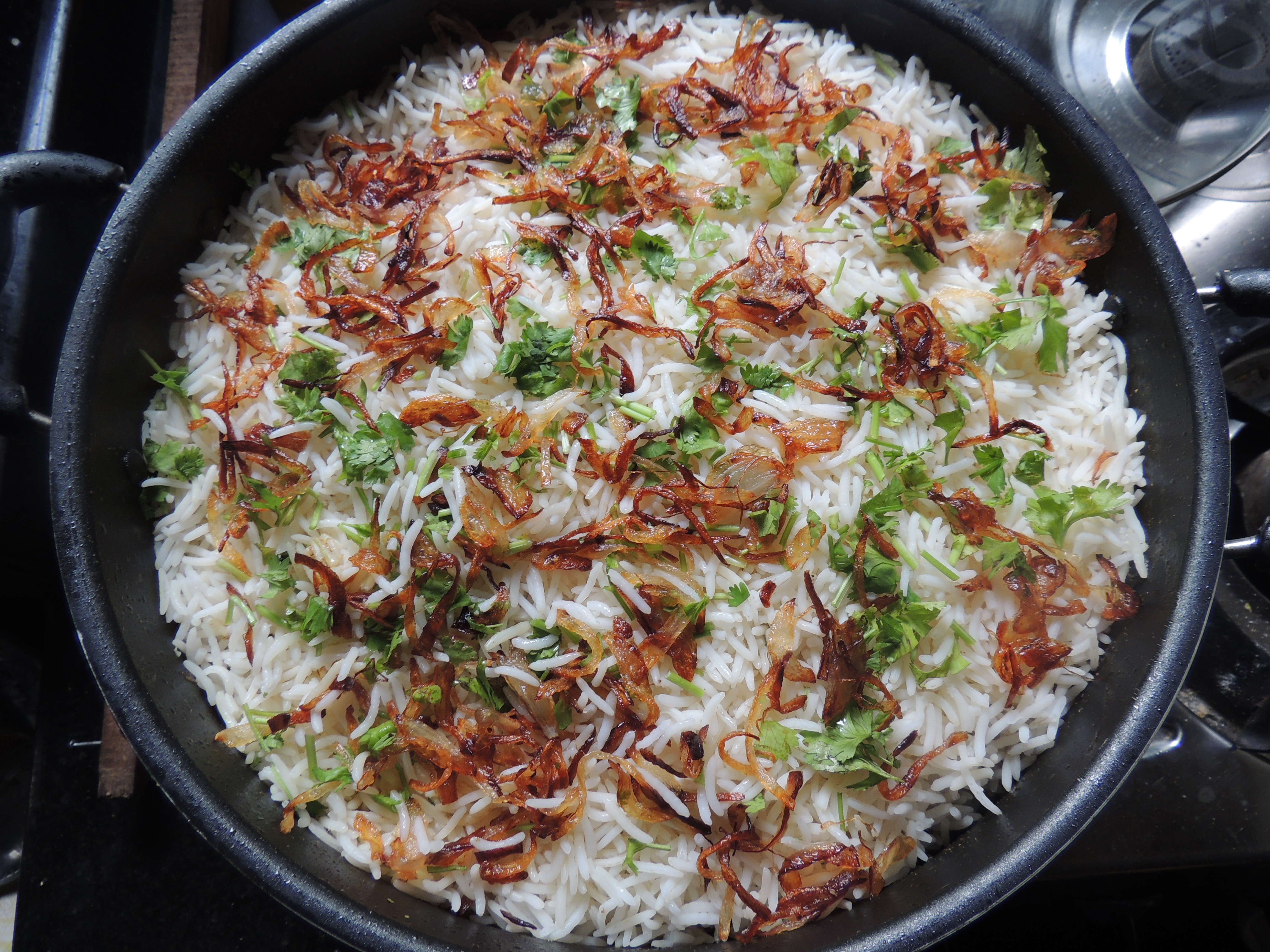 Rice with fried onions in a cauldron