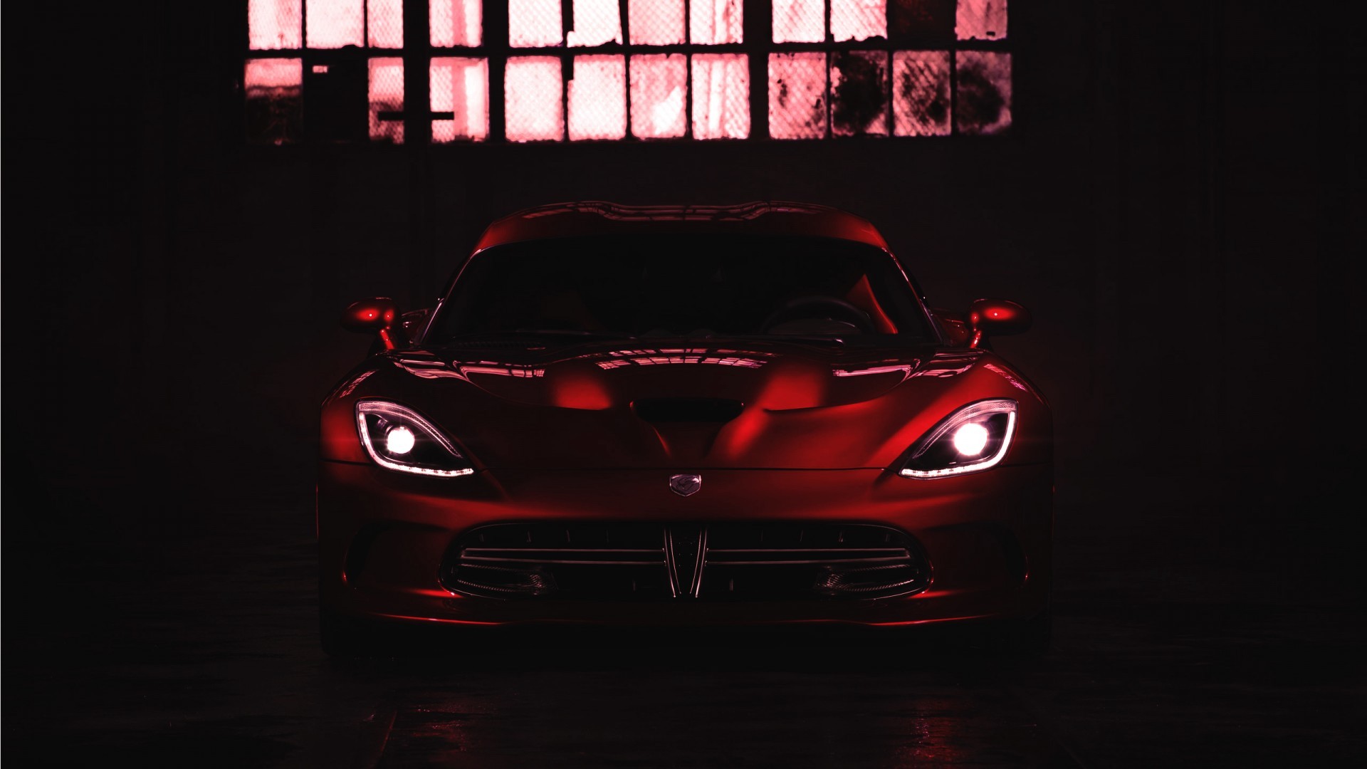 Free photo A red Dodge Viper in the dark.