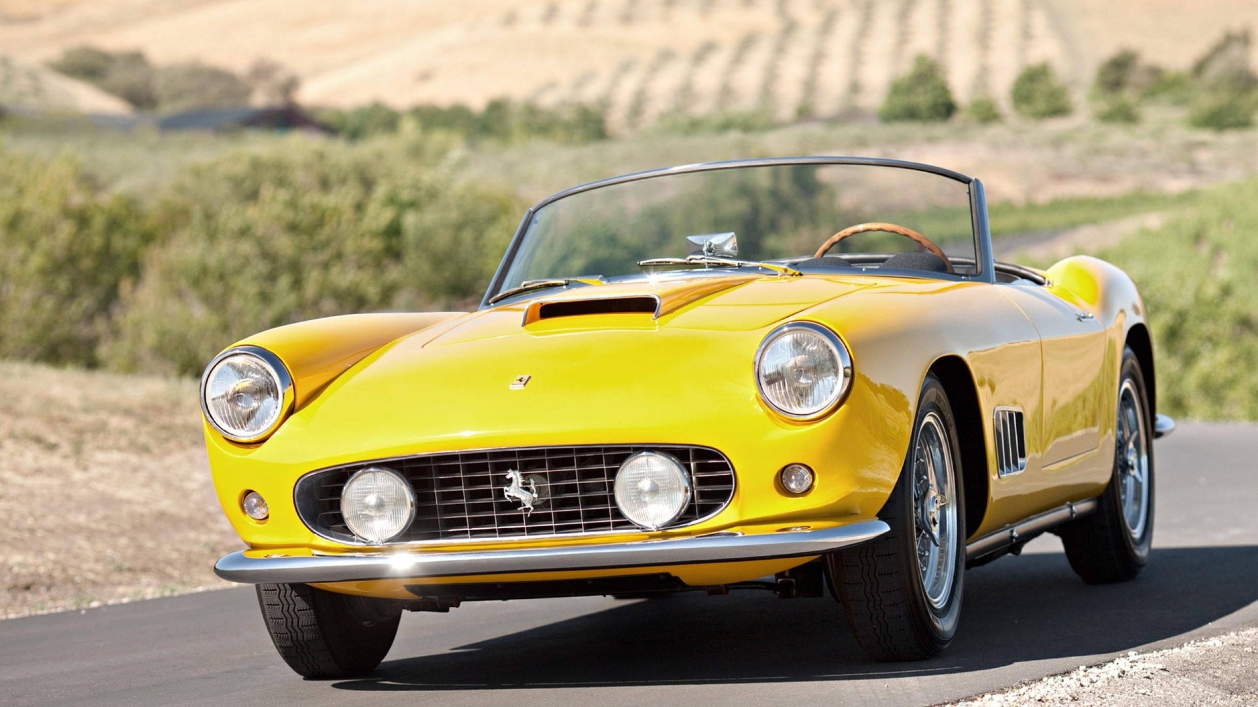 Free photo Yellow Ferrari 250 convertible.