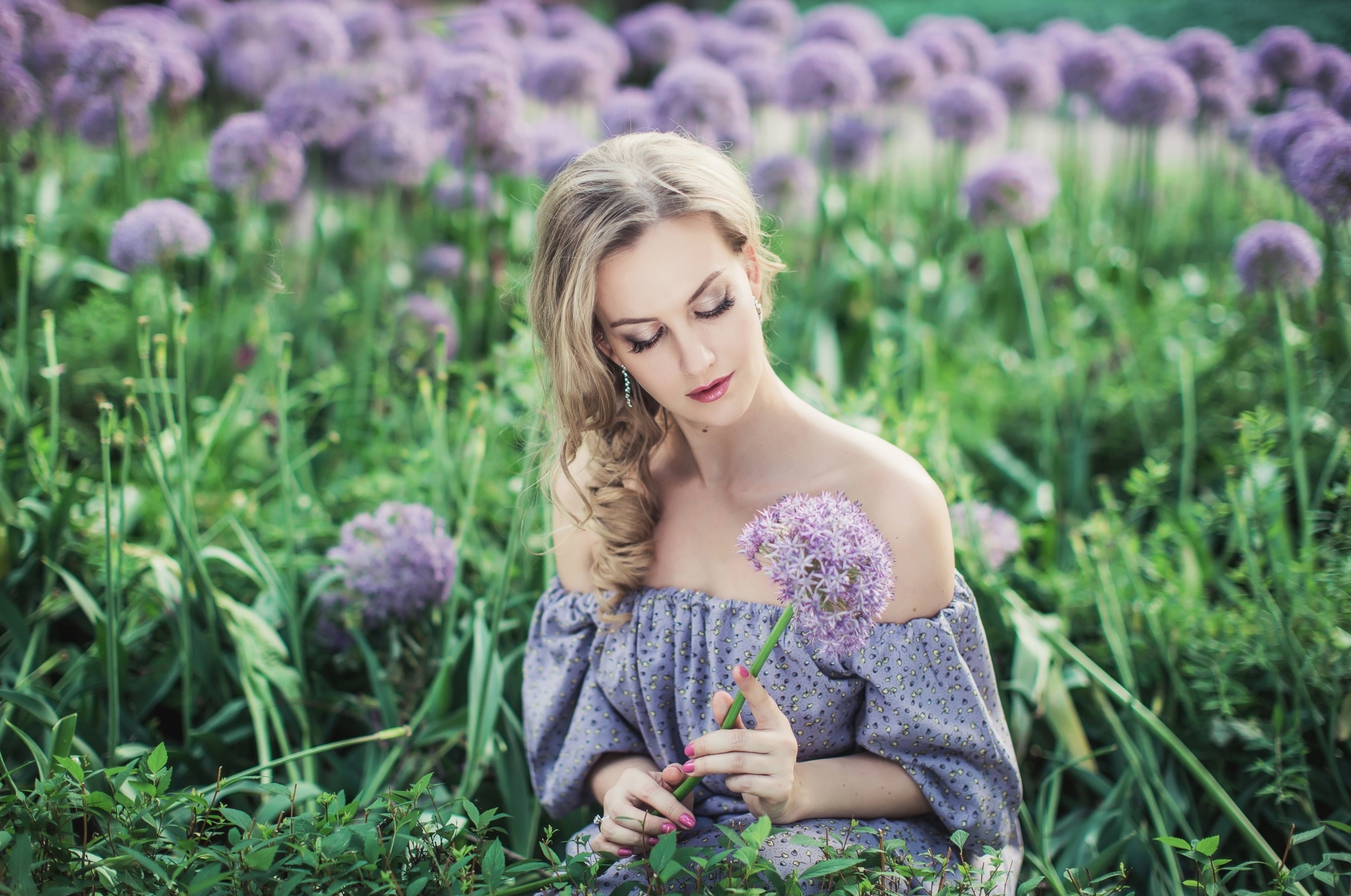 Free photo A girl sits among tall flowers