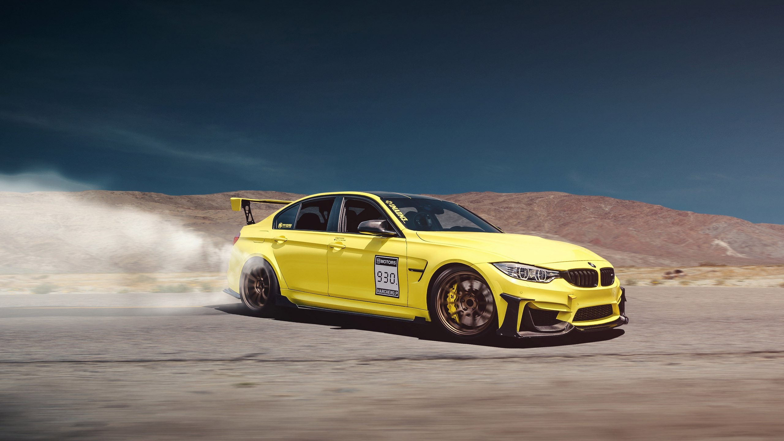 A yellow BMW M3 in a drift.