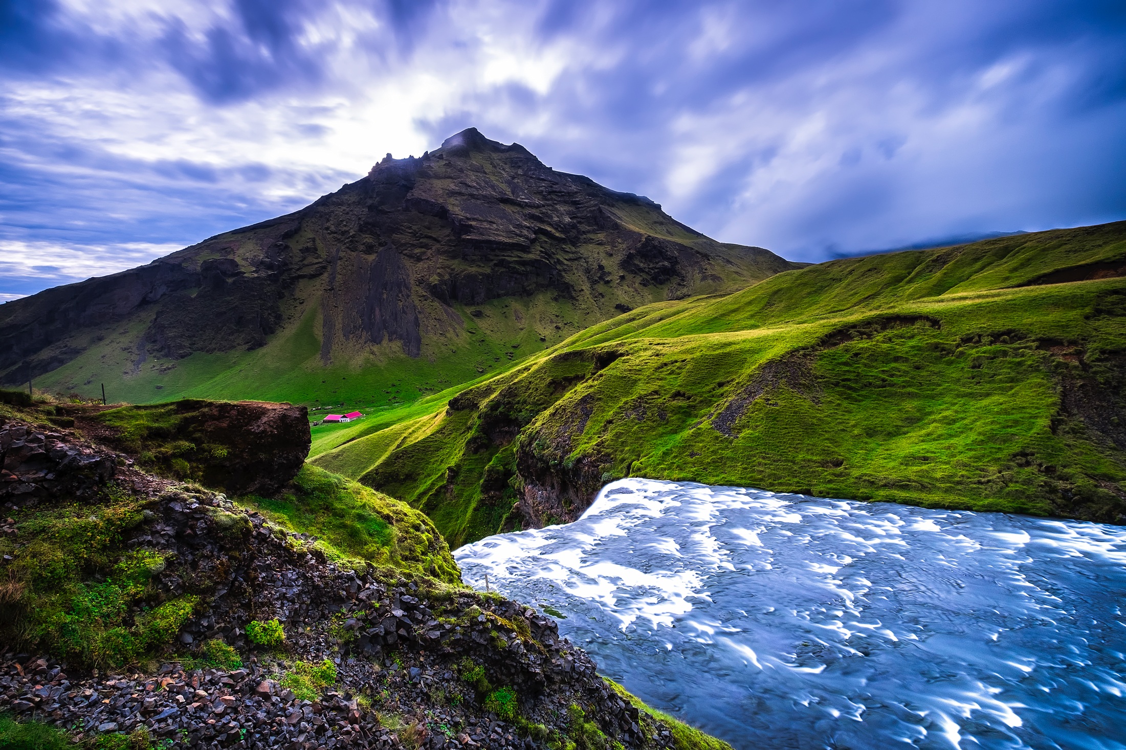 Free photo A village in a mountainous area near a waterfall