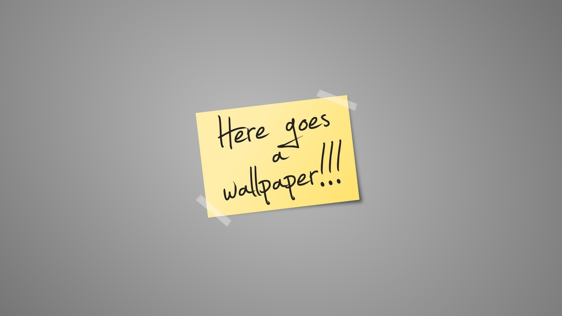A yellow sticky note with the words “Here goes a wallpaper...” attached to a gray wall.