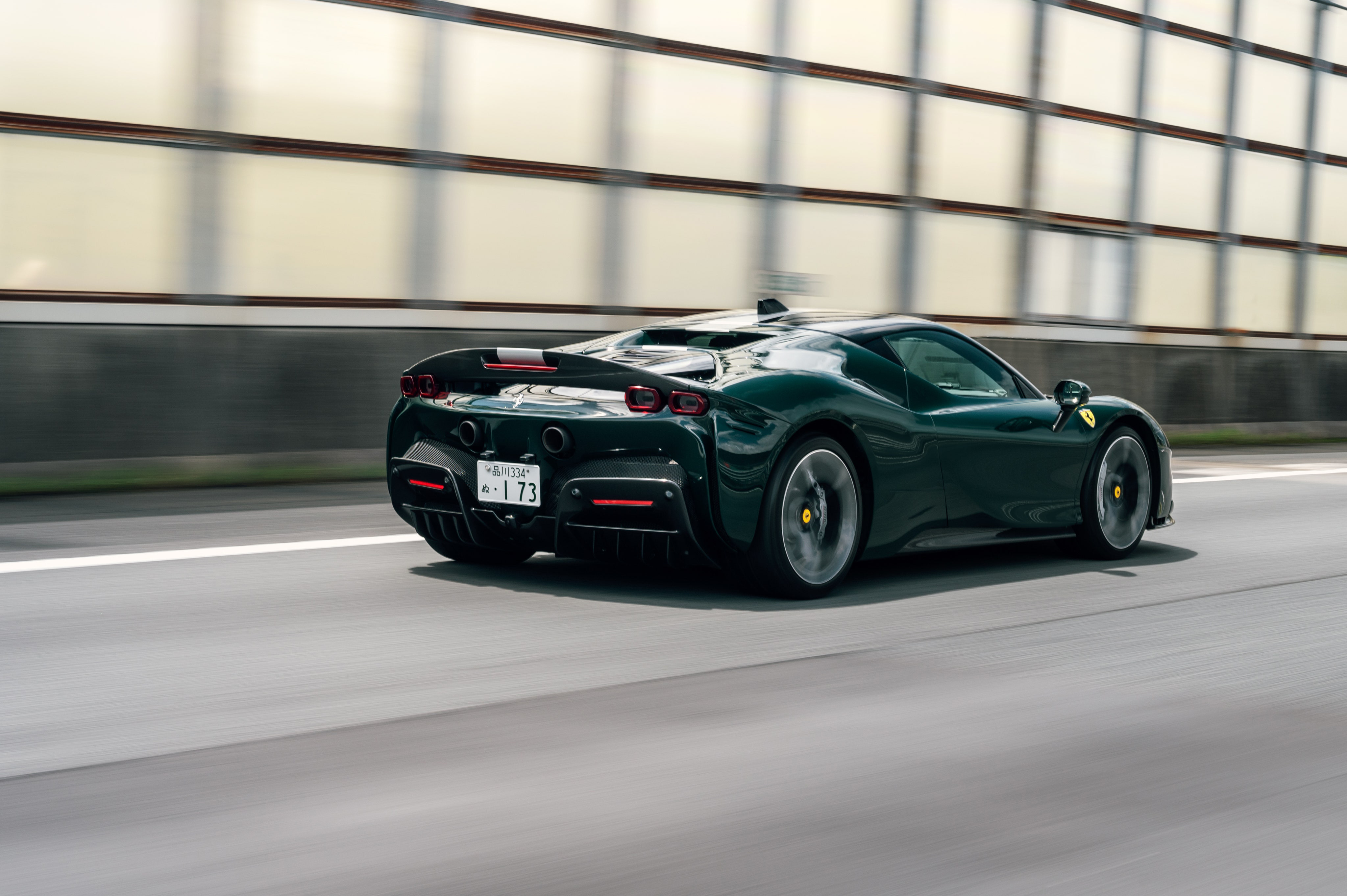 Free photo Green ferrari sf90 stradale in motion