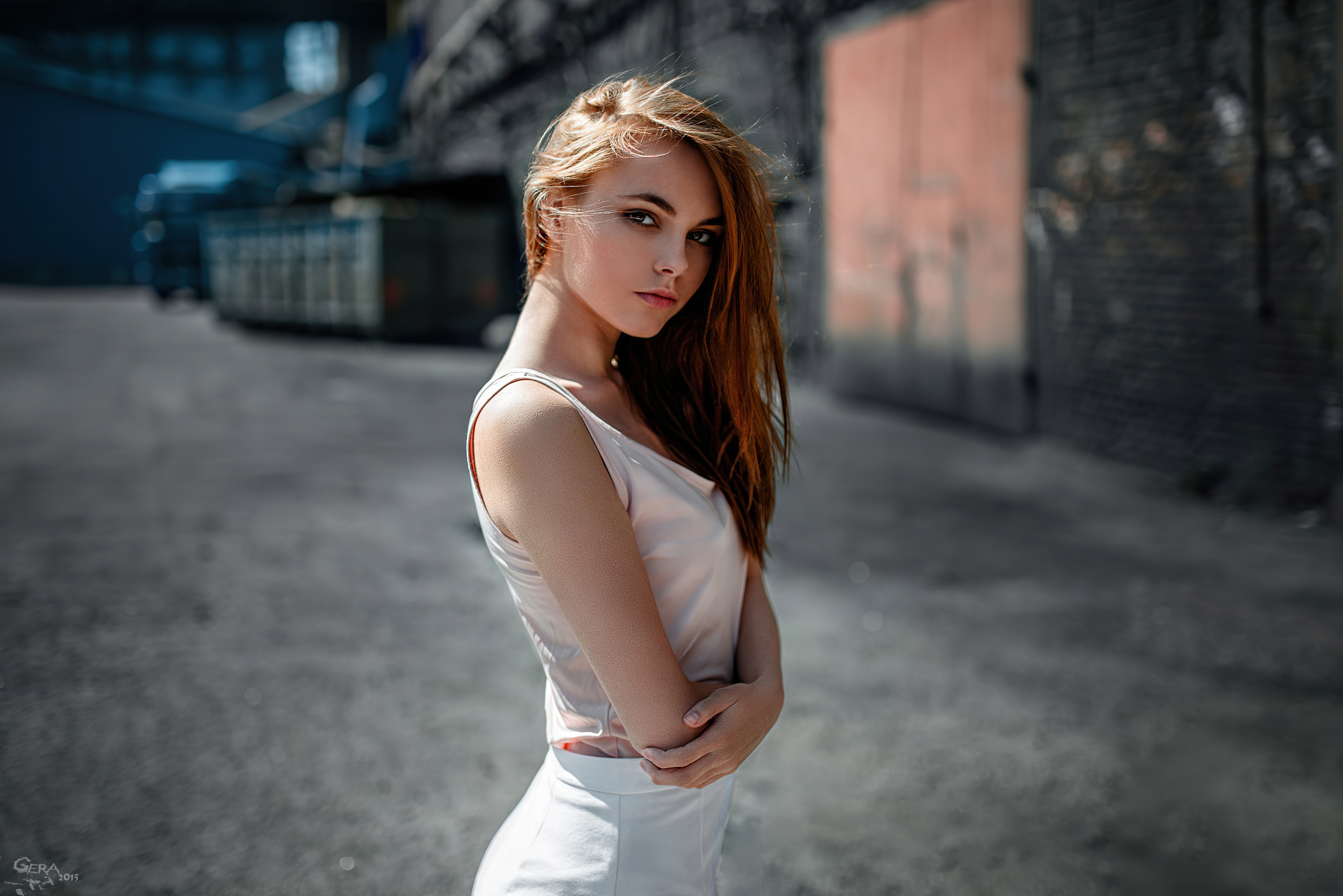 Free photo A girl in a white dress stands sideways to the photographer