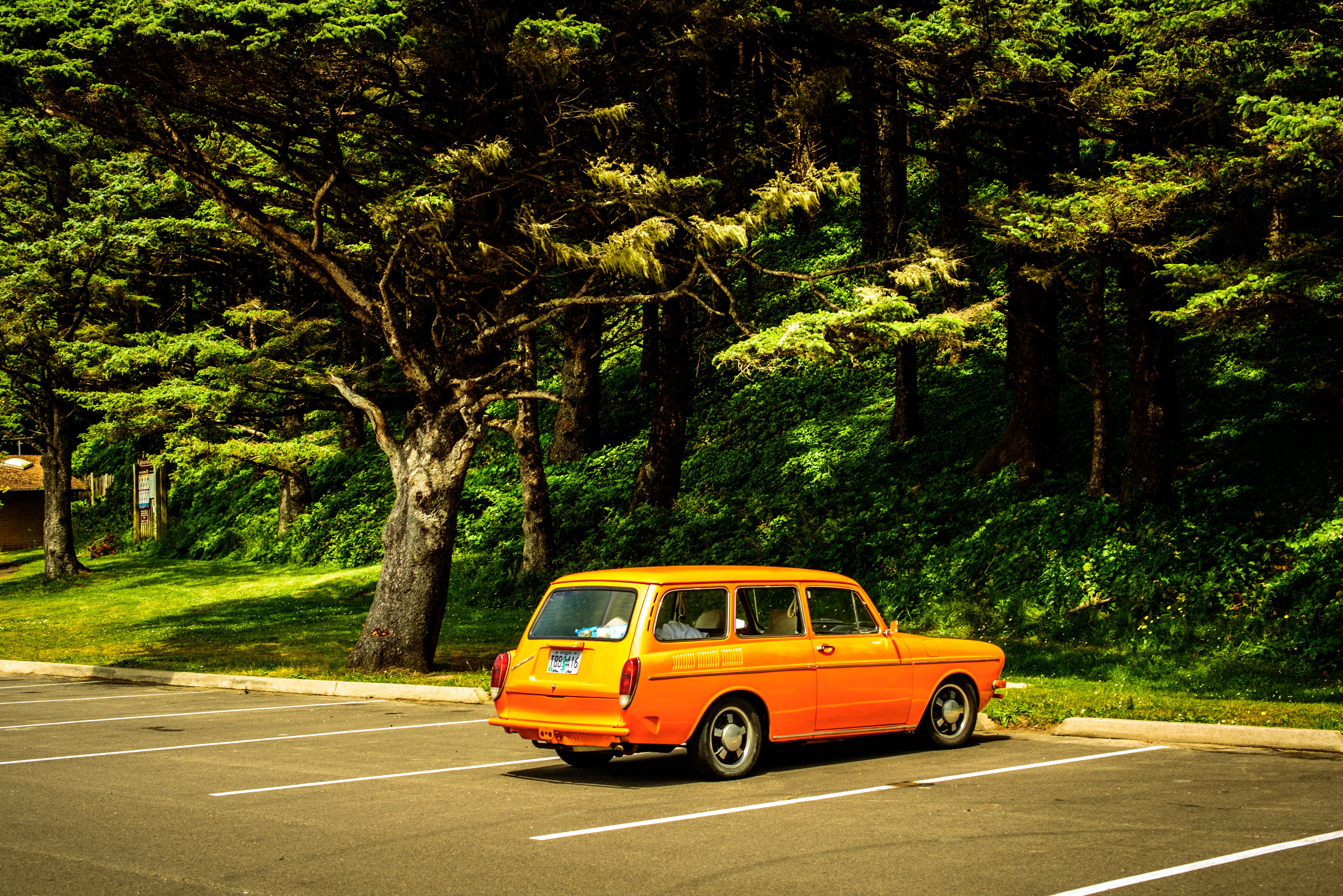 Free photo Picture of a vintage yellow car in a parking lot