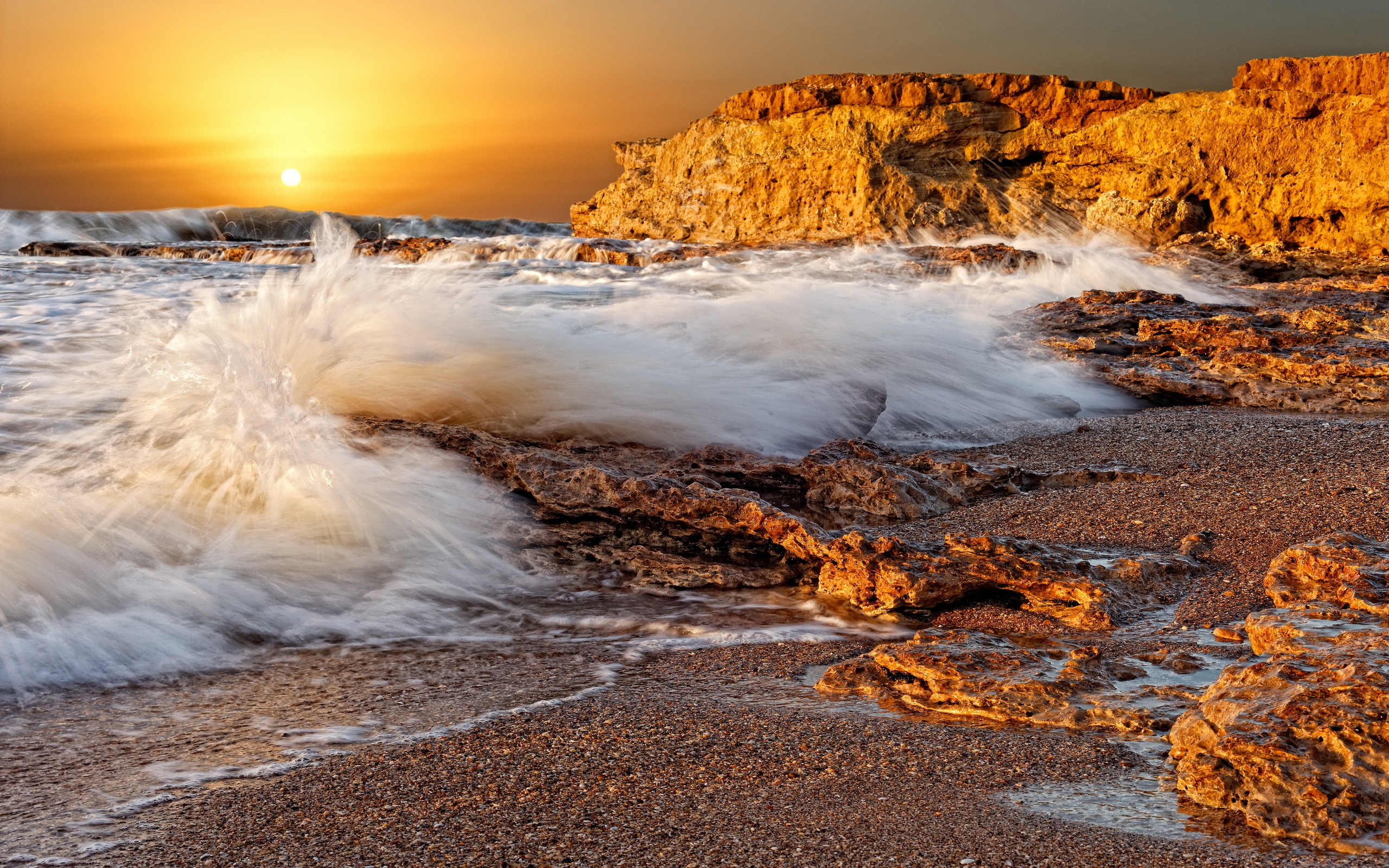 Strong waves on the beach at sunset