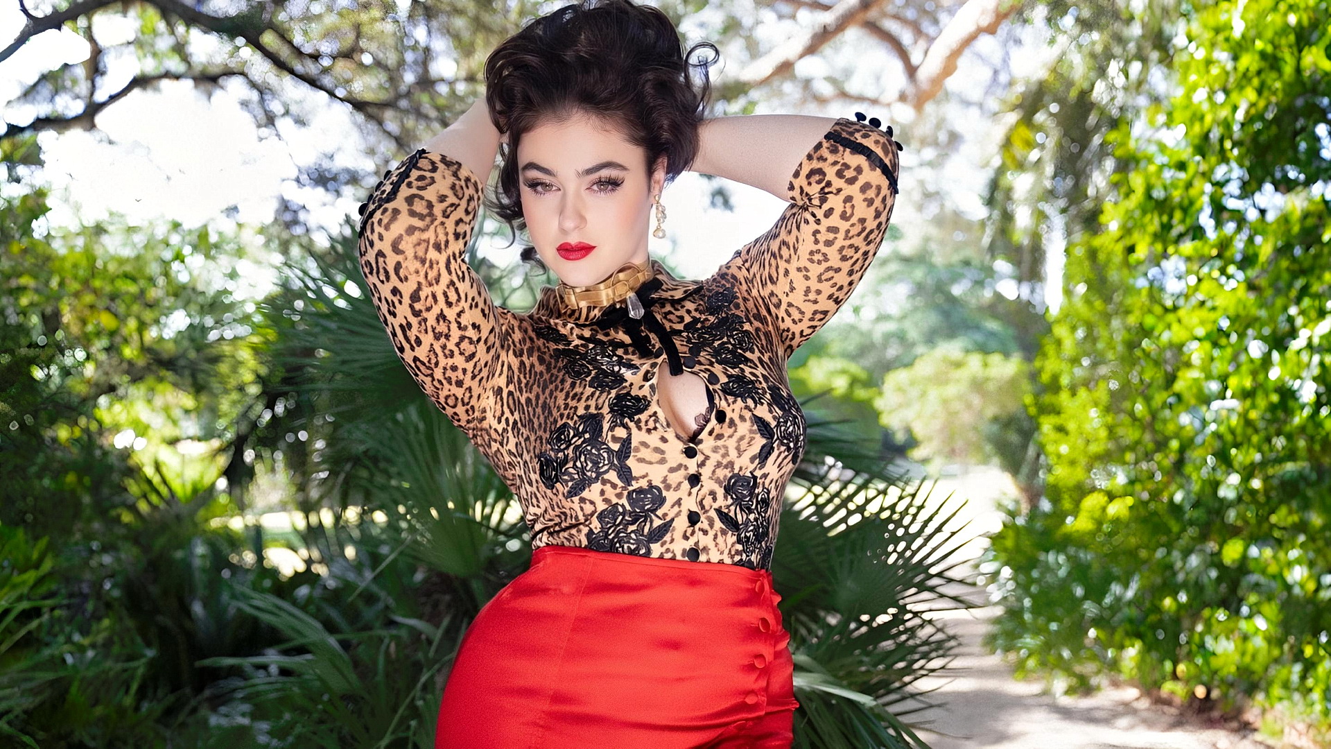 Model Stefania Ferrario stands against a natural backdrop