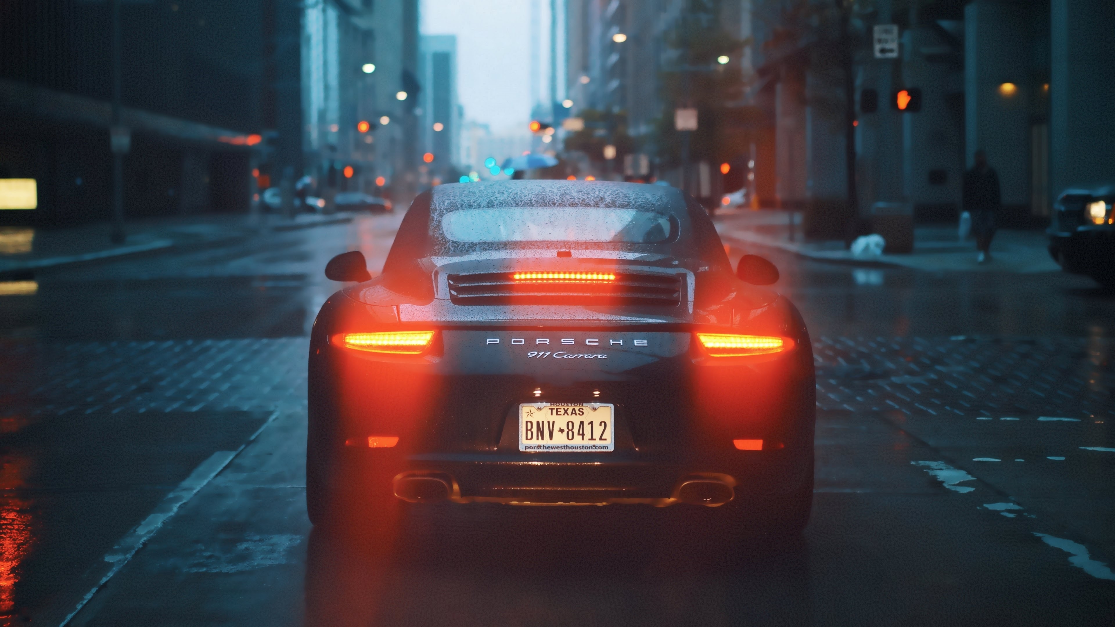 A Porsche 911 on a rainy street
