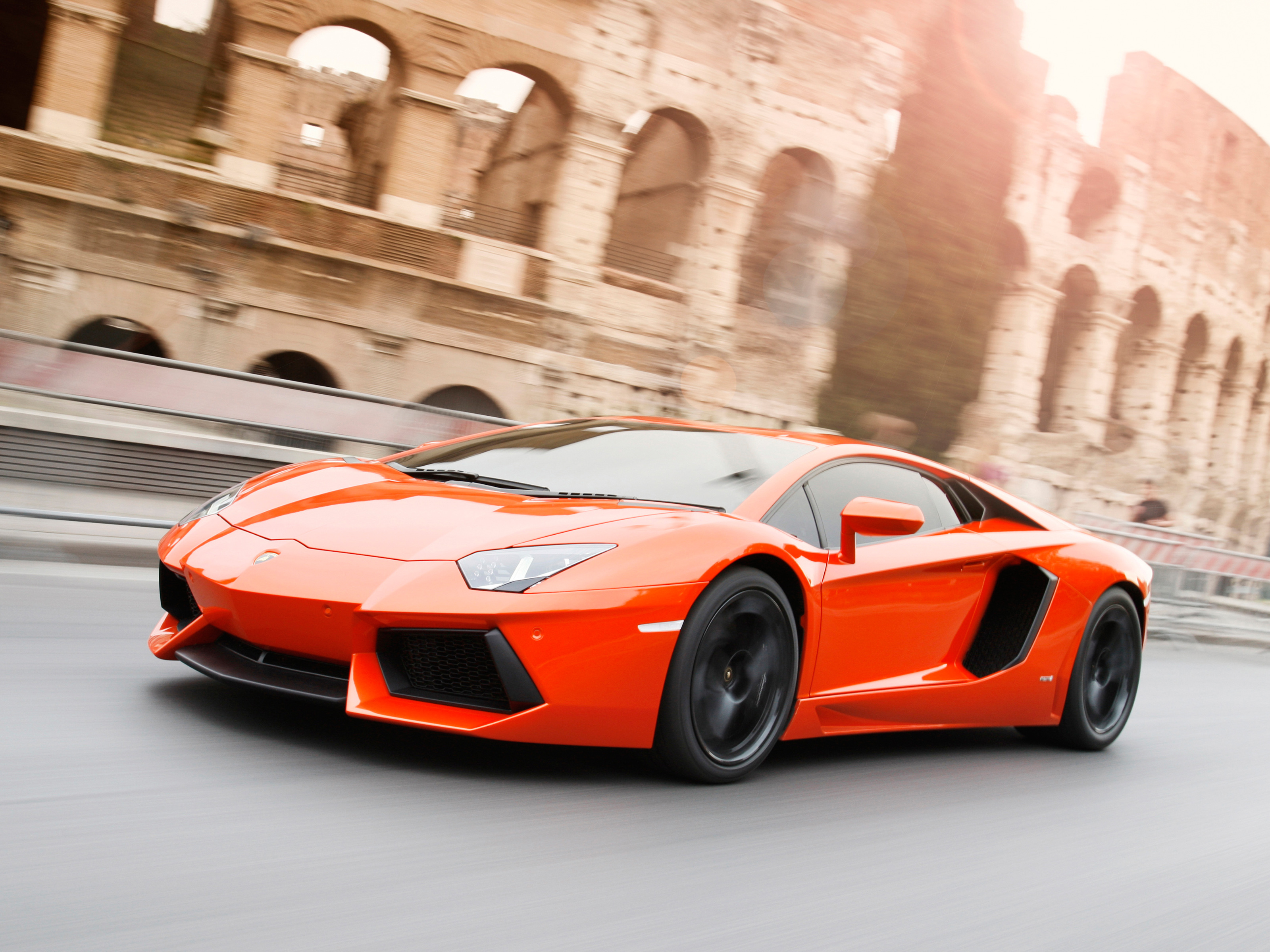 Free photo The orange Lamborghini Aventador in motion.