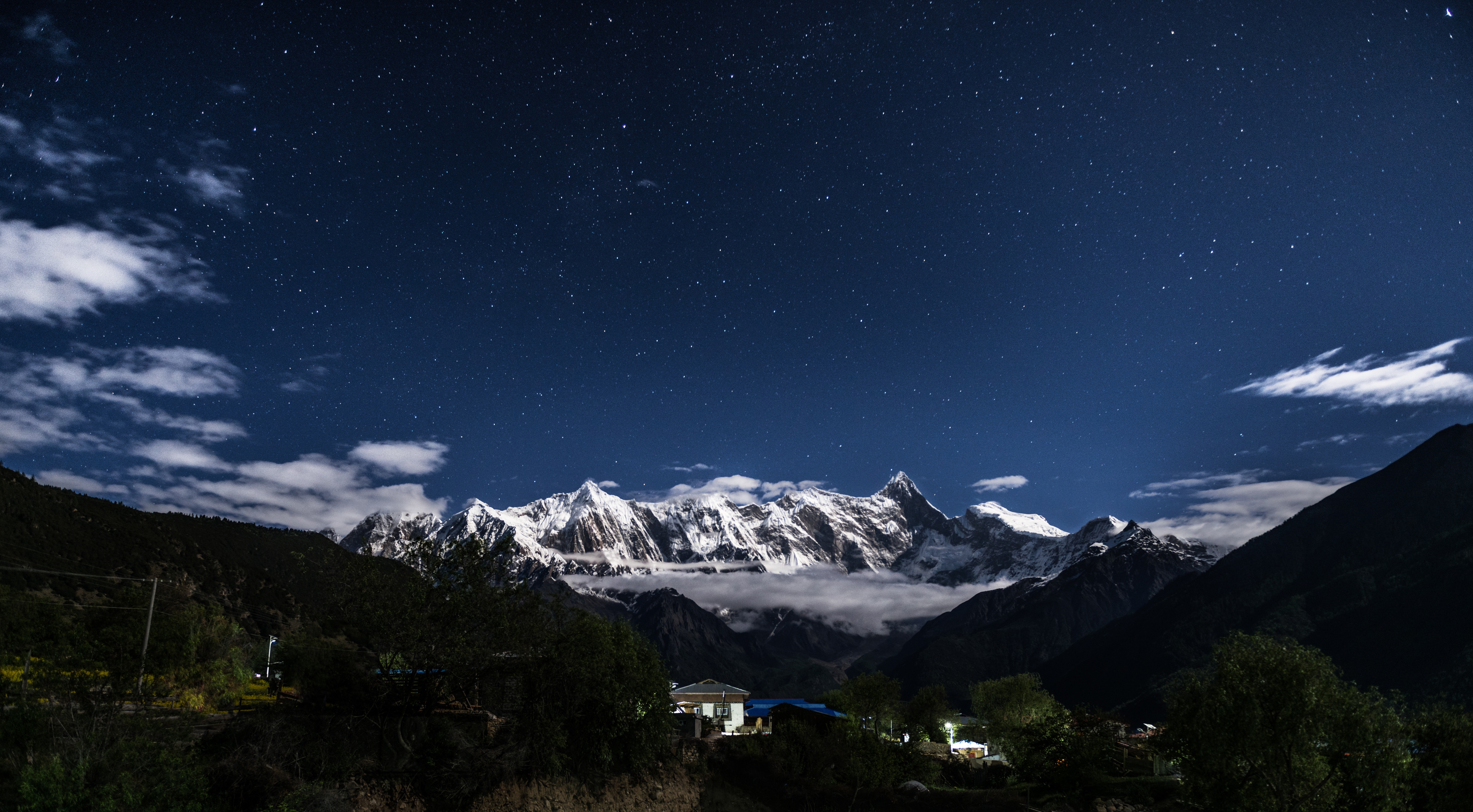 A beautiful starry sky against the backdrop of the mountains in the countryside