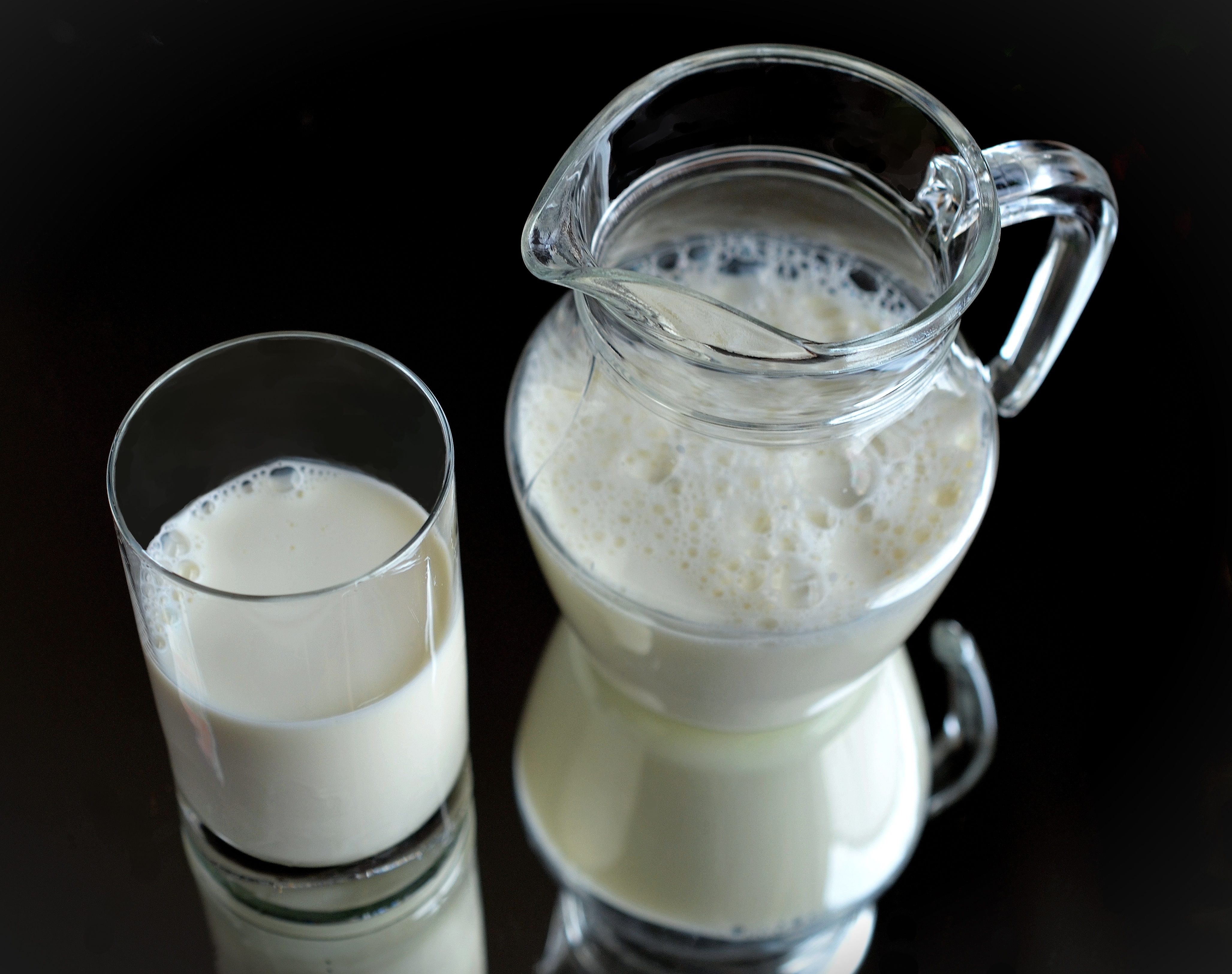 Free photo Decanter with milk on black background