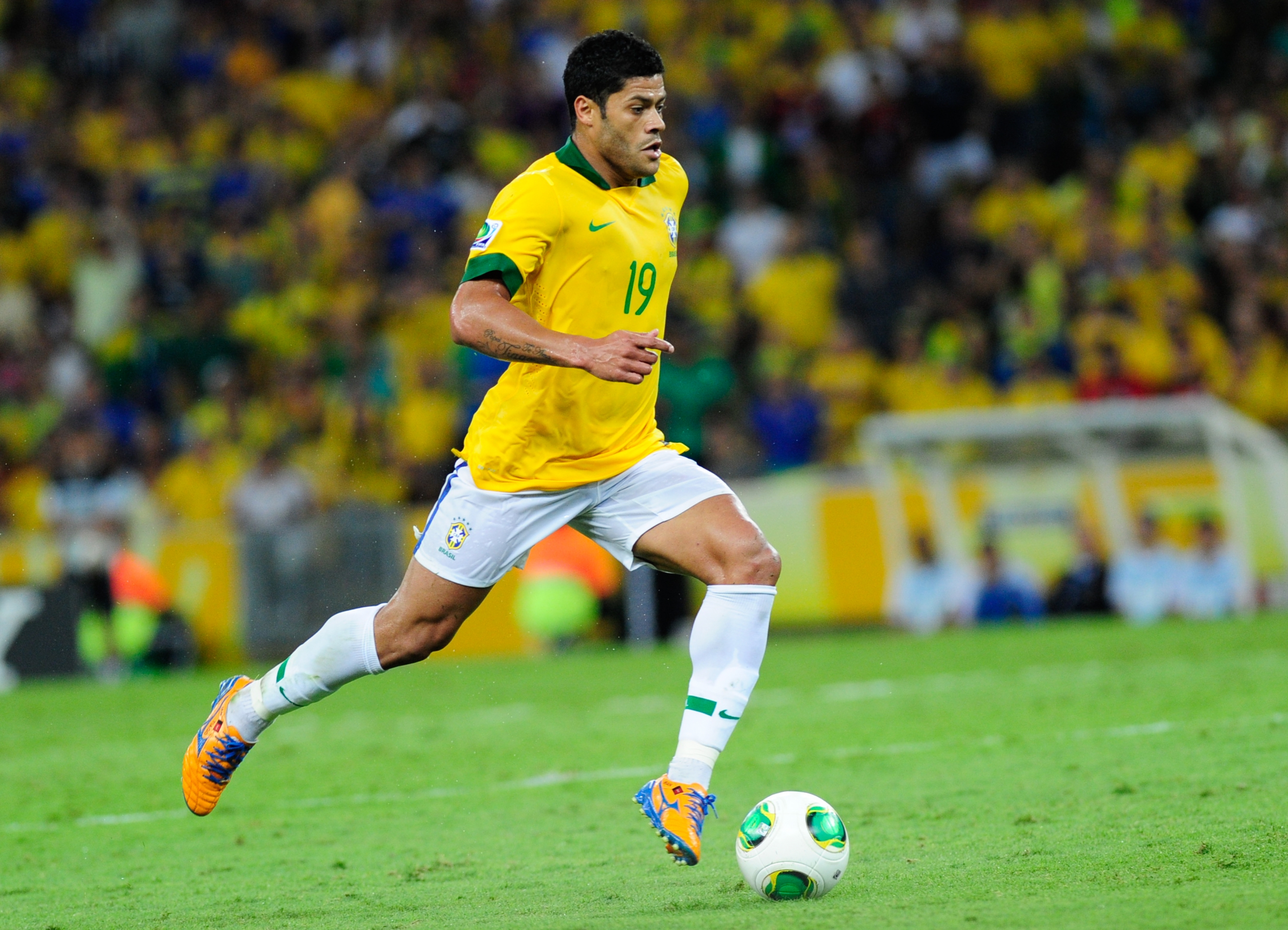 Free photo A soccer player runs with the ball down the field