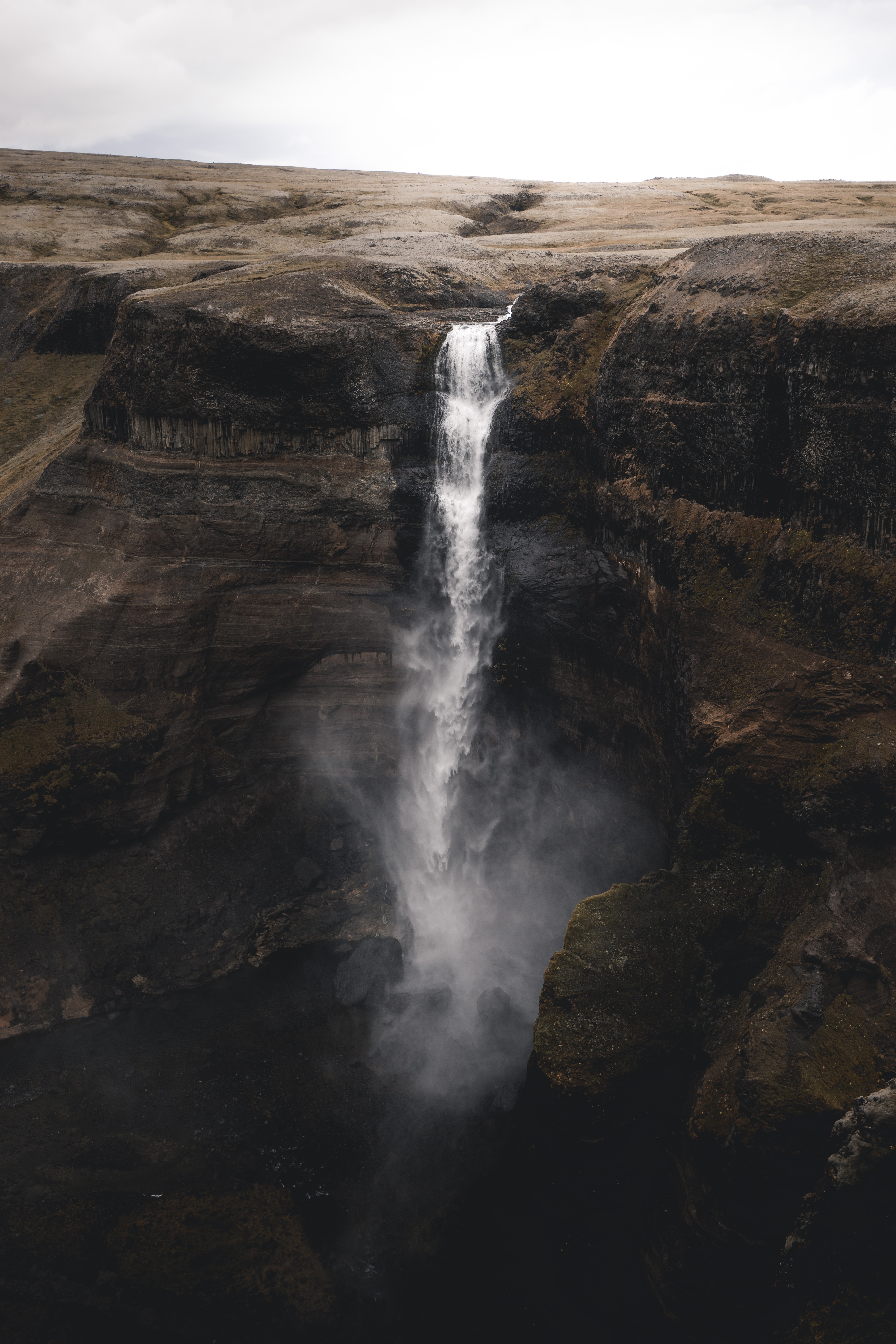 Free photo A river running along a rock with a waterfall in the gorge