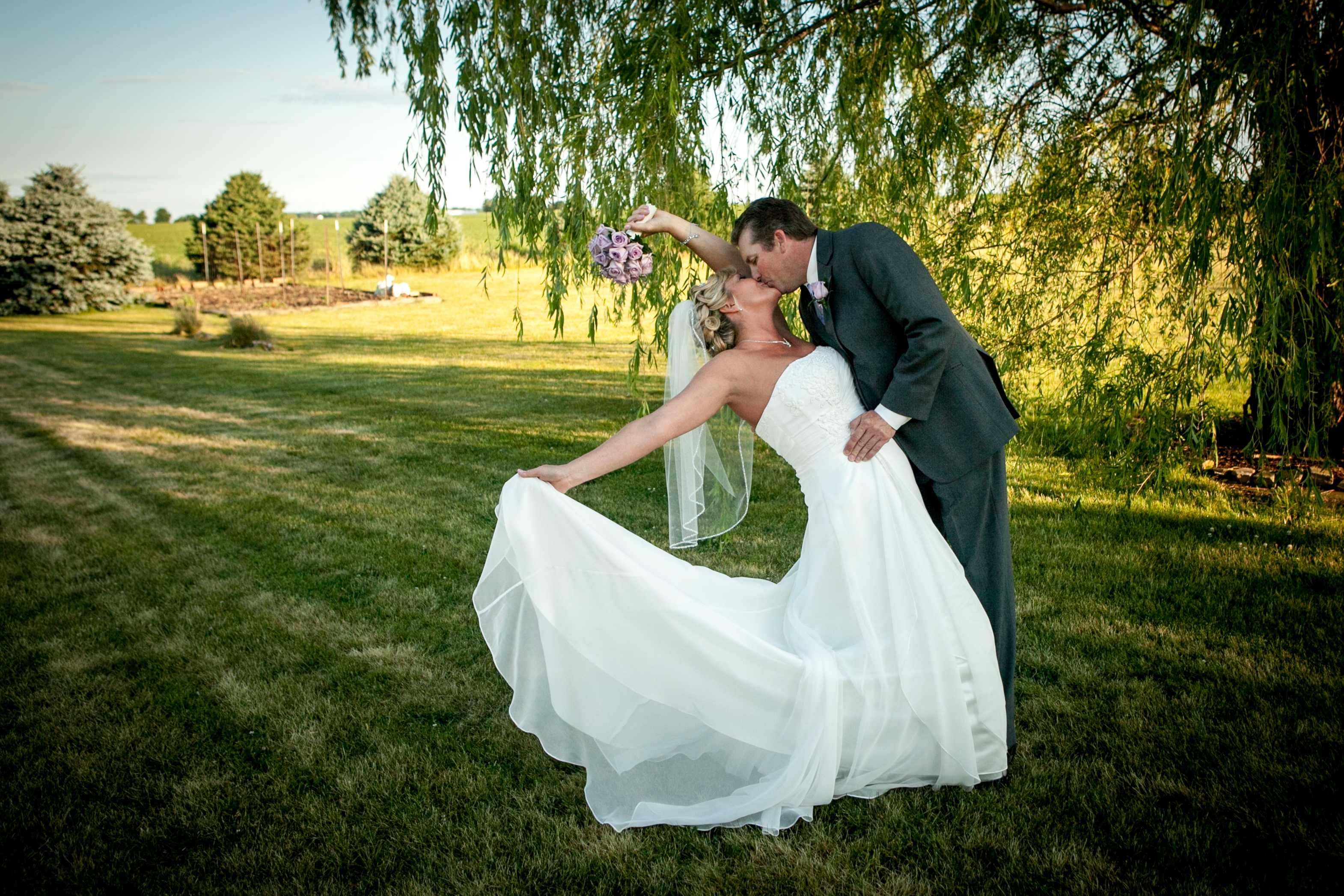 Free photo Wedding couple kissing on camera