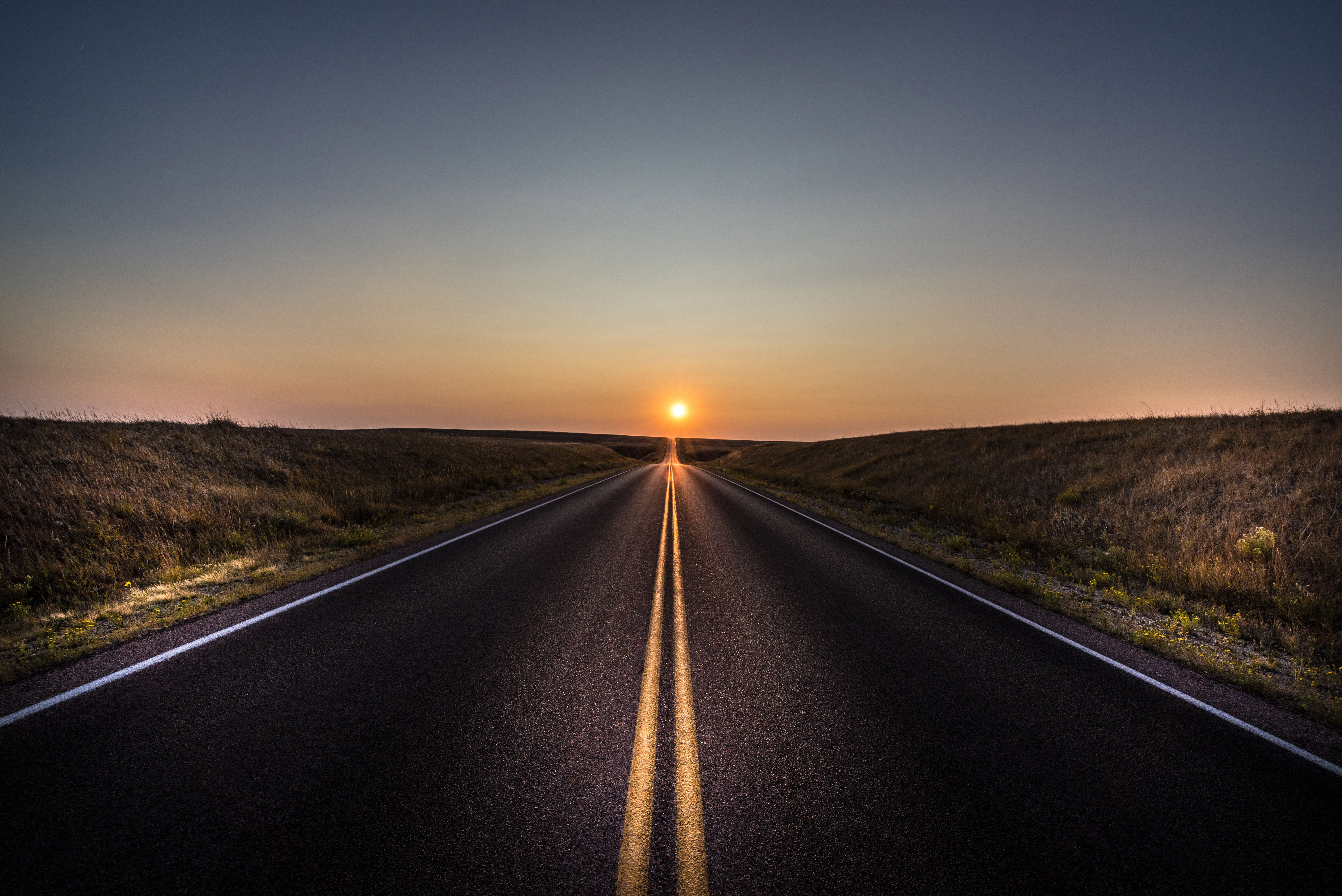 Бесплатное фото Длинная асфальтированная дорога ведущая к солнцу