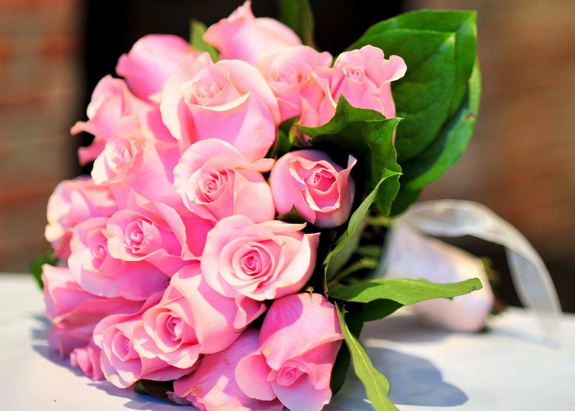 Бесплатное фото Букет розовых роз лежит на столе