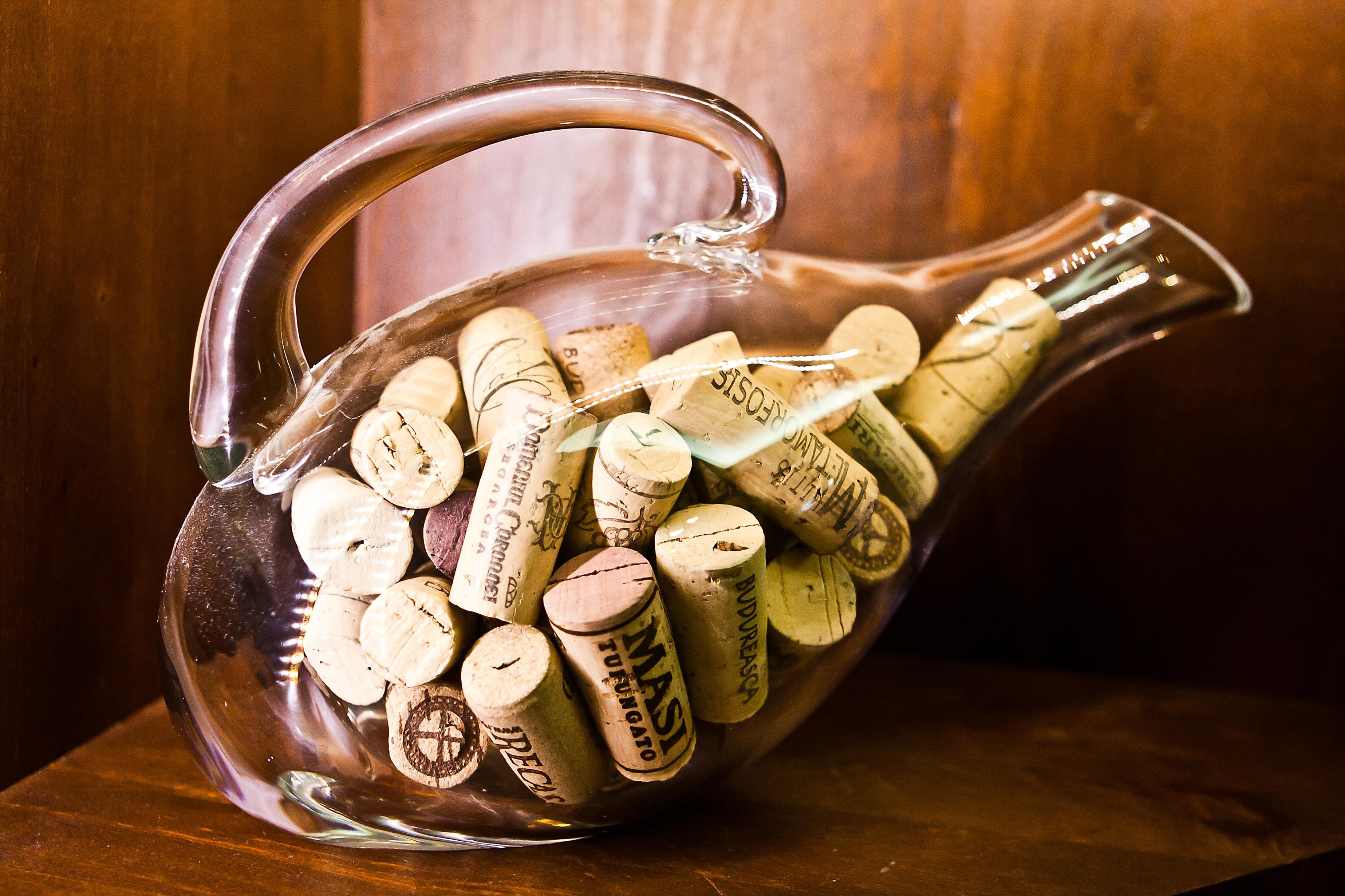 A clear decanter filled with wine corks.