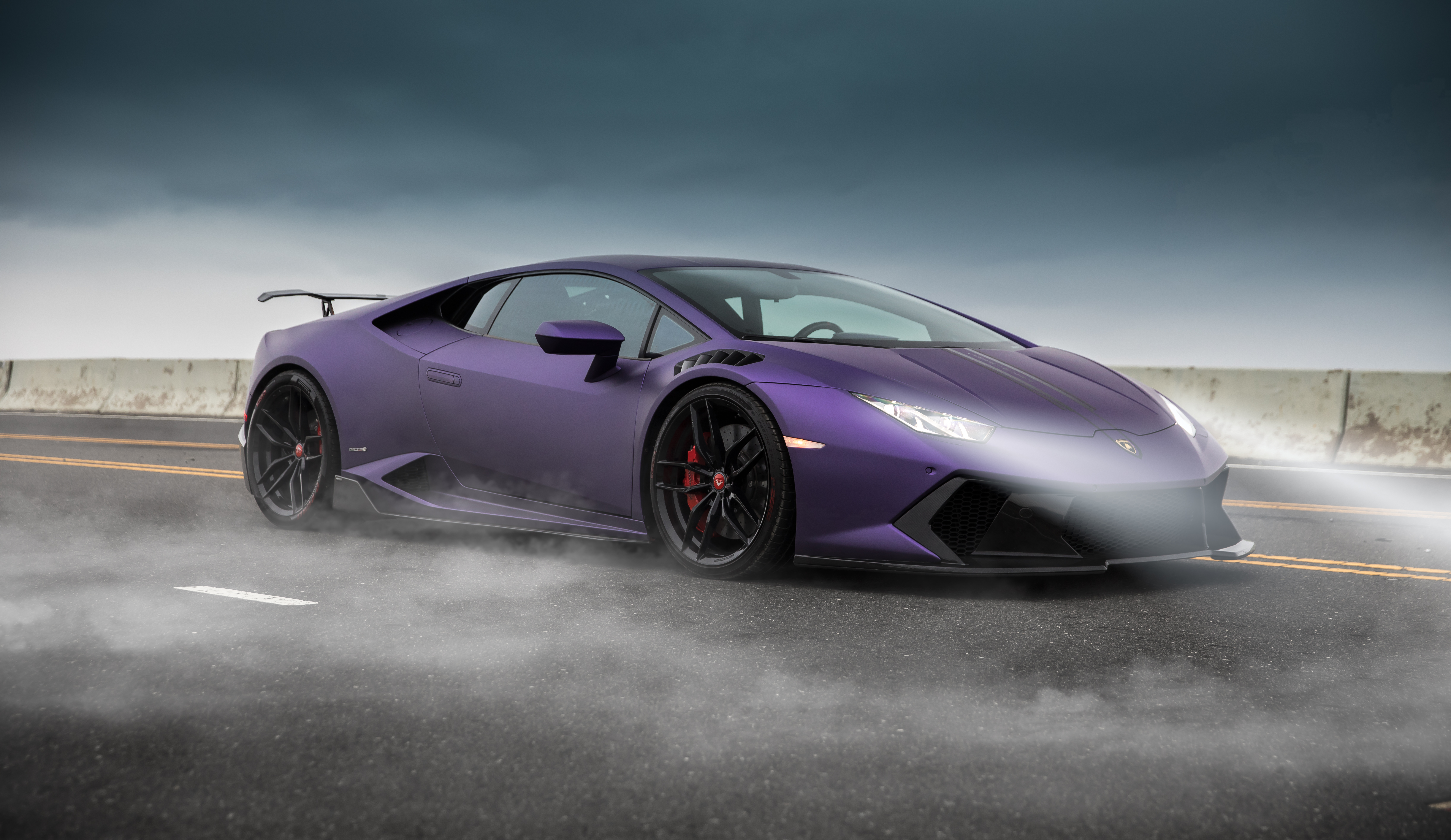 Purple Lamborghini Huracan on a smoky road