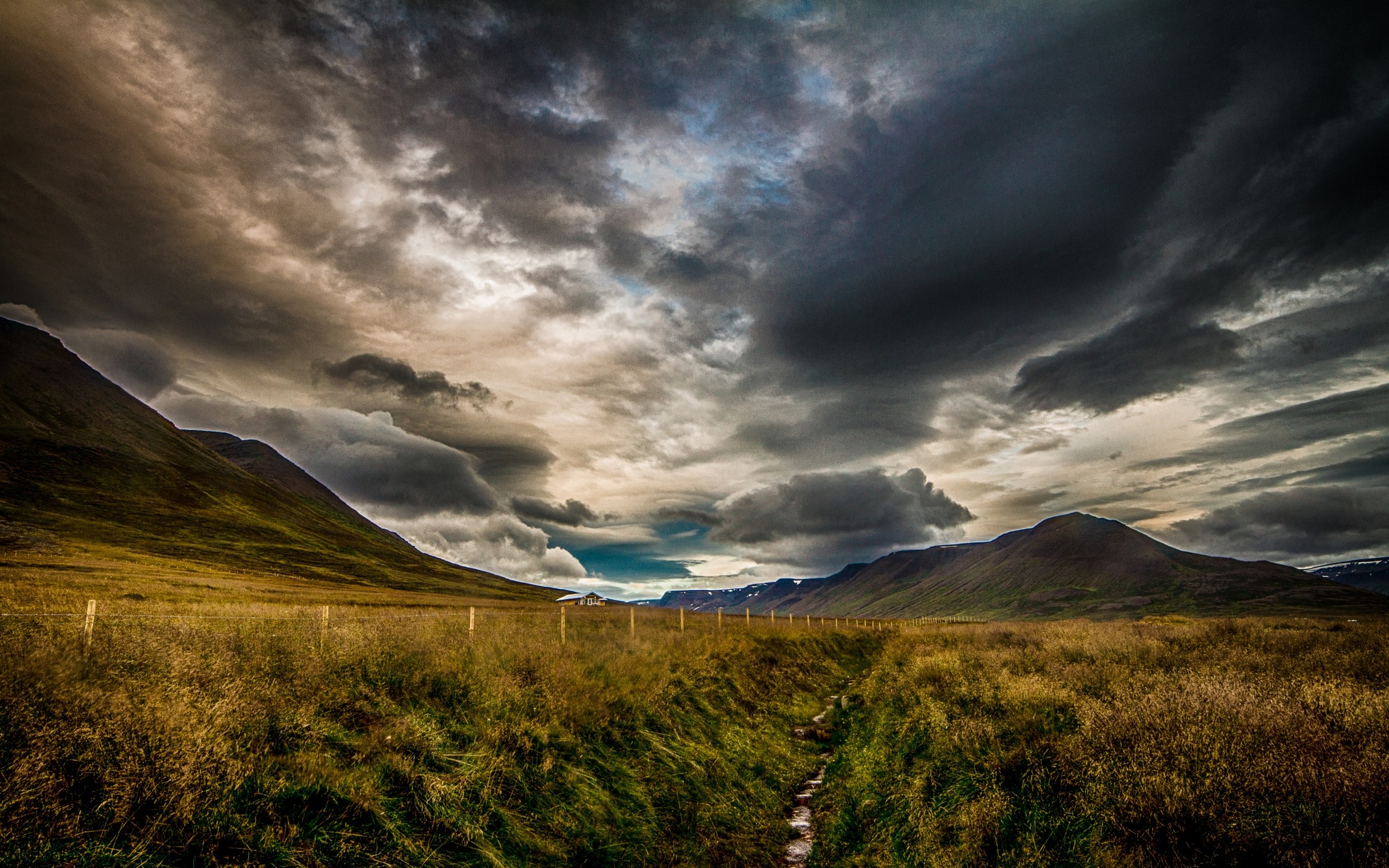 Free photo Dark clouds over a field of mountains