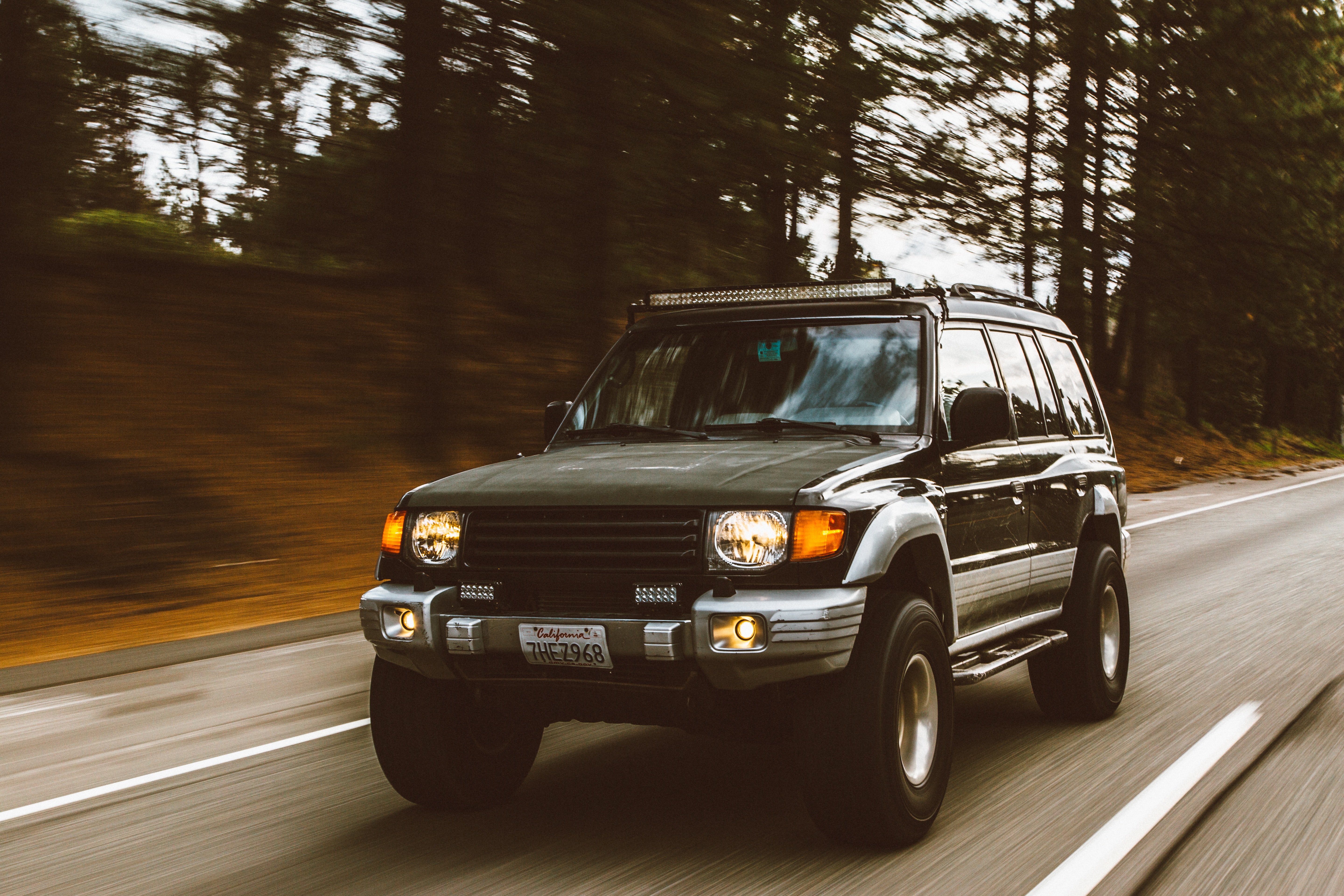 Free photo Mitsubishi Pajero driving on a country road